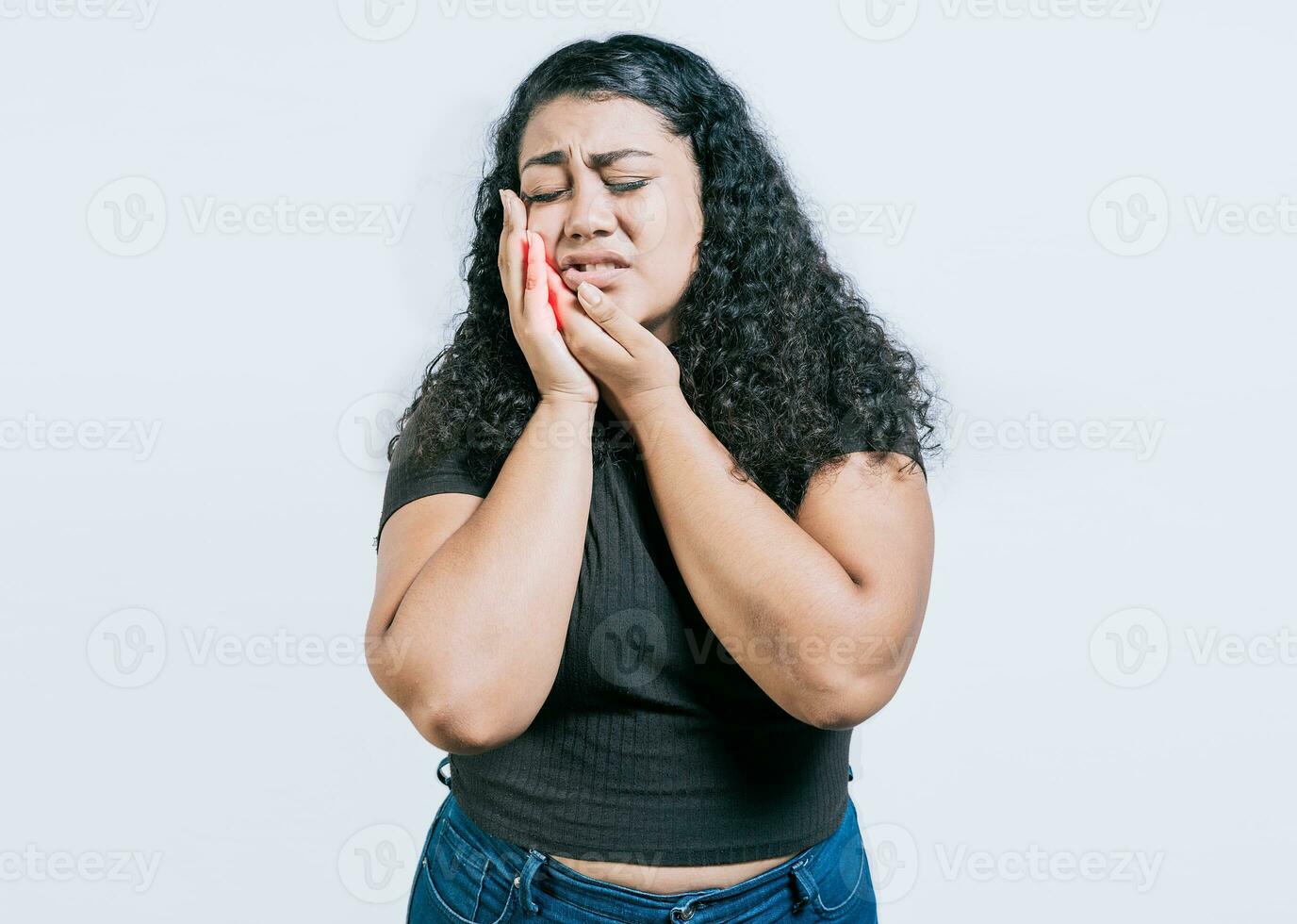 Young woman suffering with toothache isolated. Girl rubbing cheek with toothache on white background. photo