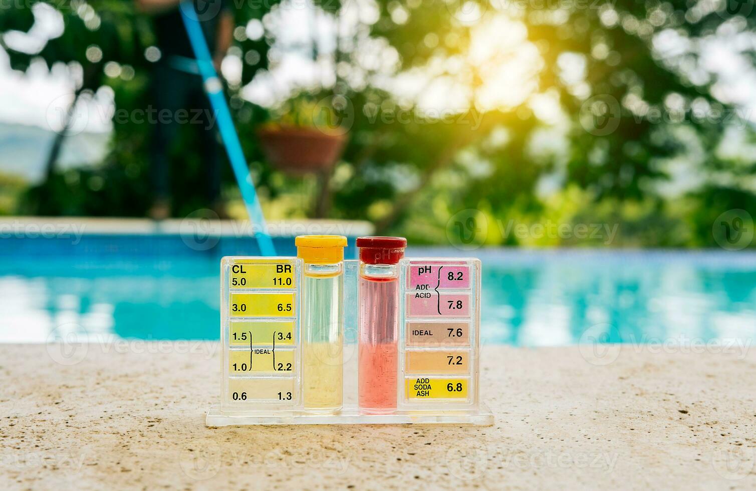 Tester kit to measure chlorine and ph in swimming pools. Pool water PH tester kit on the edge of the swimming pool photo