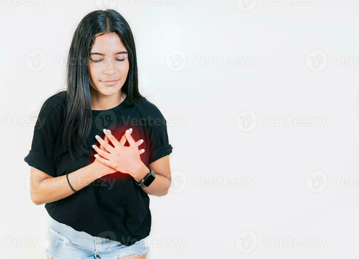 Young woman with tachycardia. Concept of people with heart problems. Latin woman with heart pain on isolated background photo