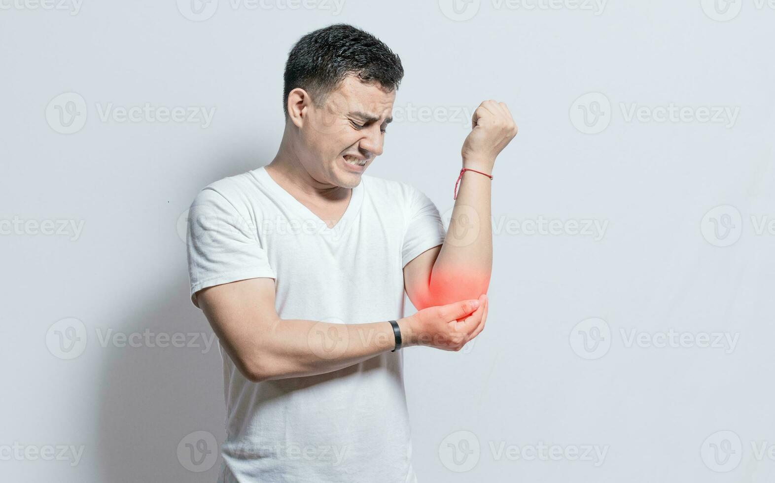 Person with elbow pain, concept of a man with rheumatism elbow pain, man massaging sore elbow, man with elbow cramp photo