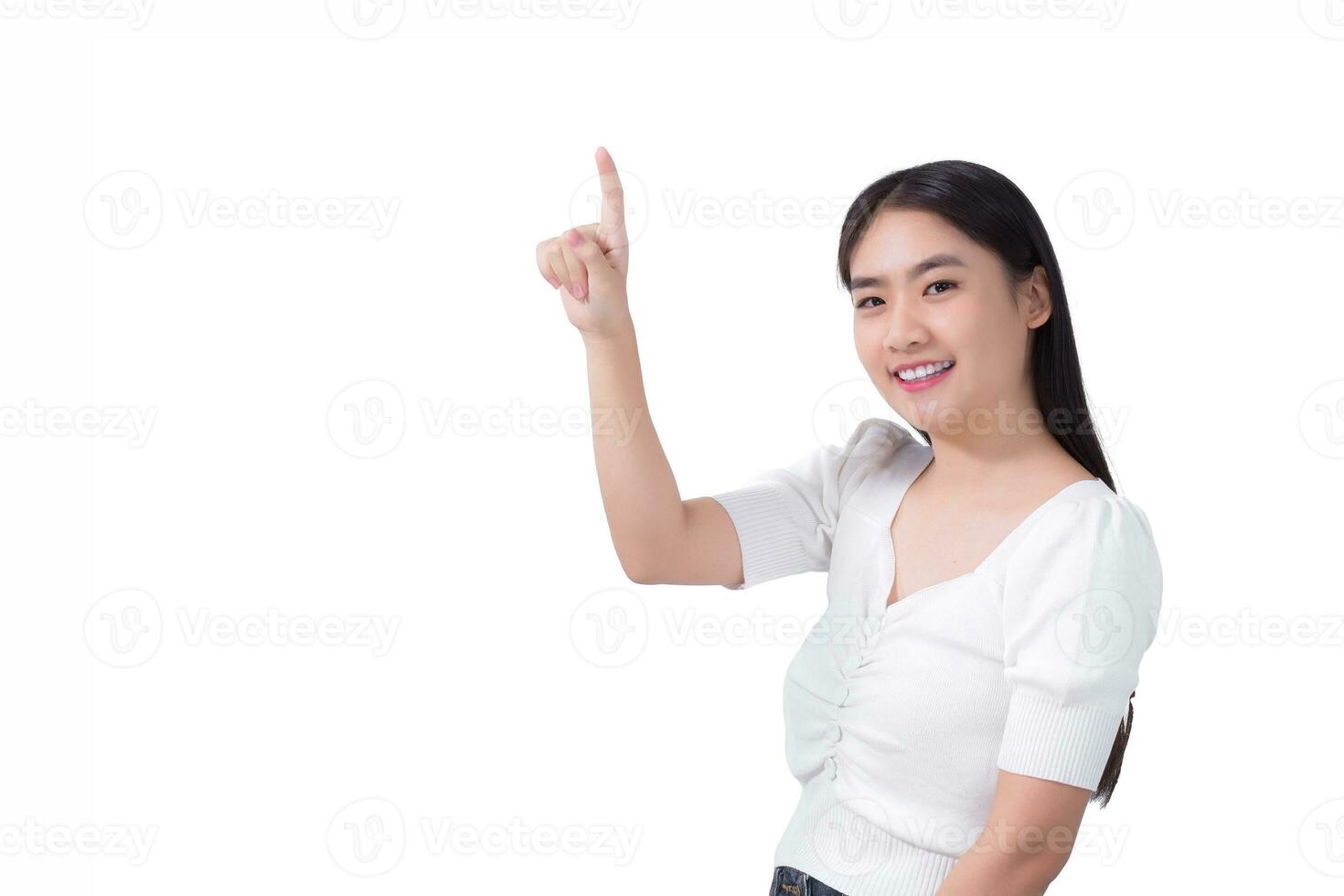 Asian girl with black long hair wears white shirt smile and point her hand to present something on the white background. photo