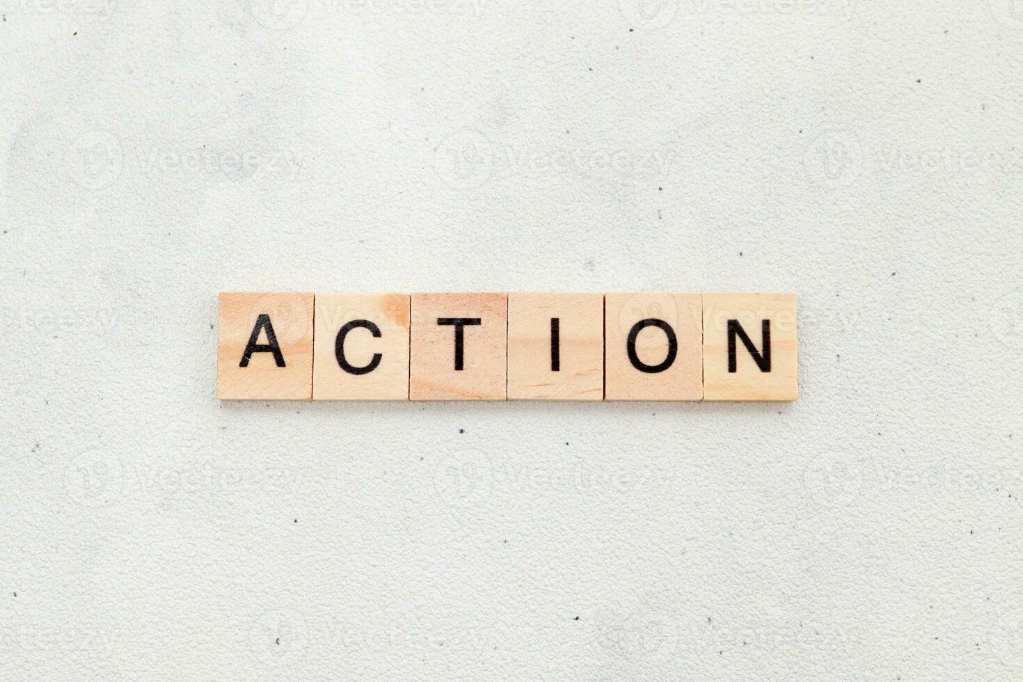 Top view of Action word on wooden cube letter block on white background. Business concept photo
