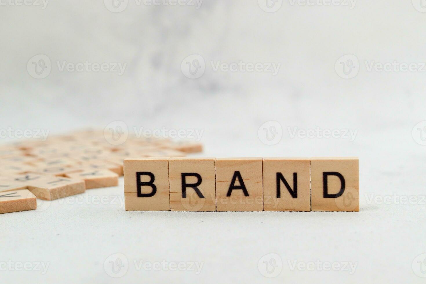 Top view of Brand word on wooden cube letter block on white background. Business concept photo