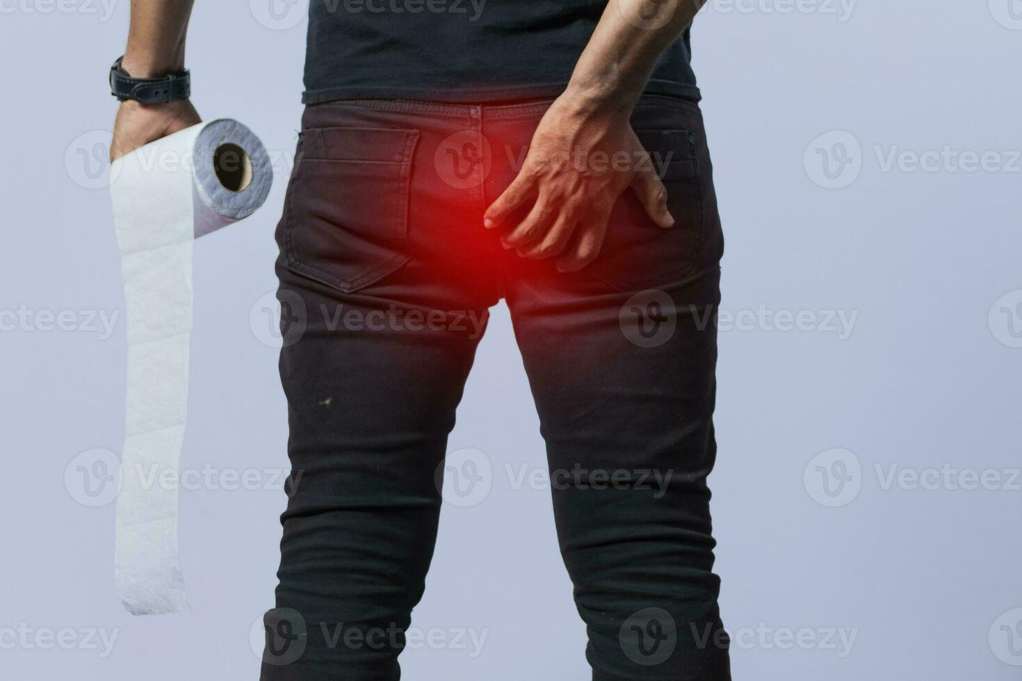 People with toilet paper in hand touching his buttock, Man with diarrhea problem, person with hemorrhoid problem on isolated background photo
