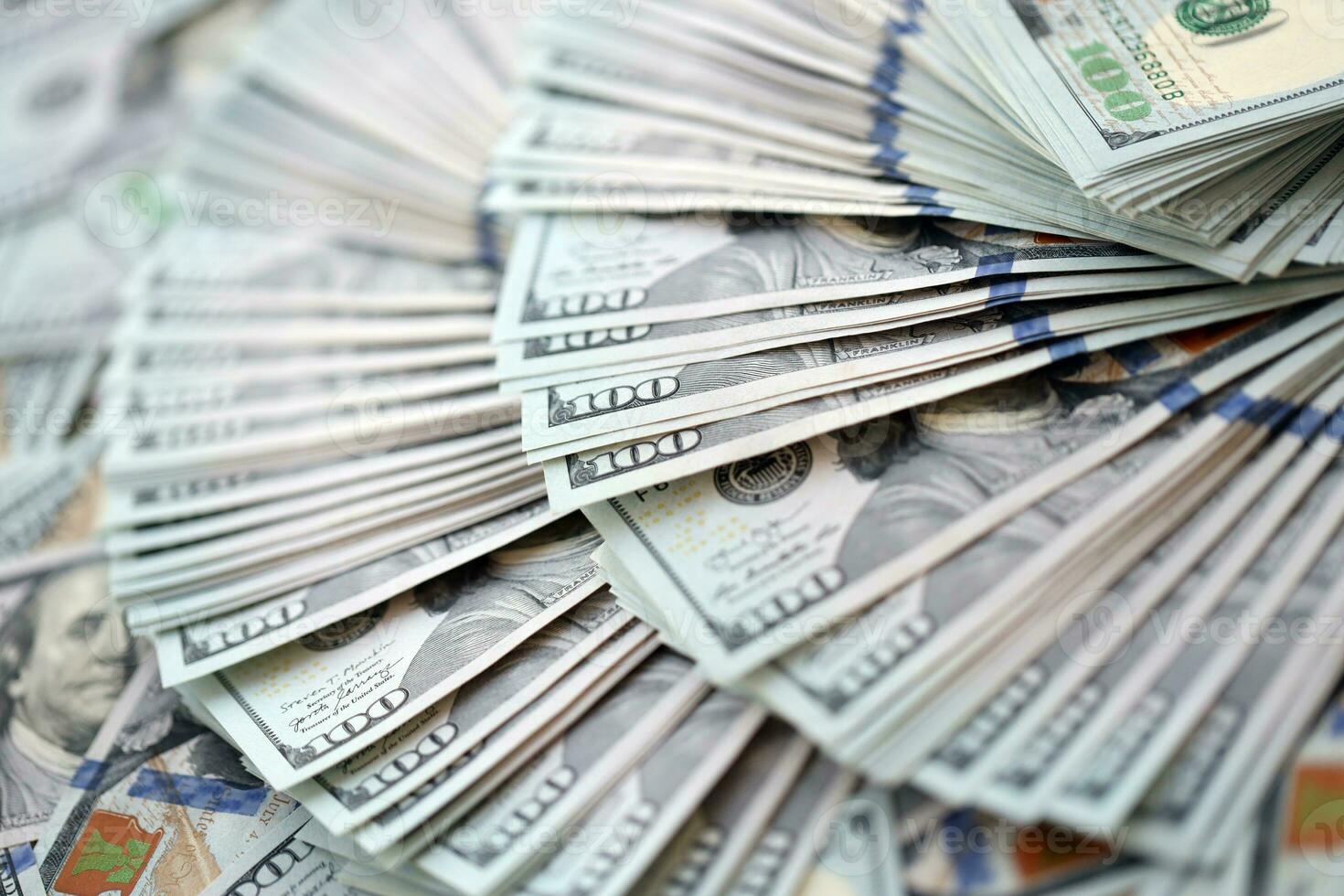 Very big amount of US hundred dollar bills. Huge quantity of united states currency notes on flat table photo