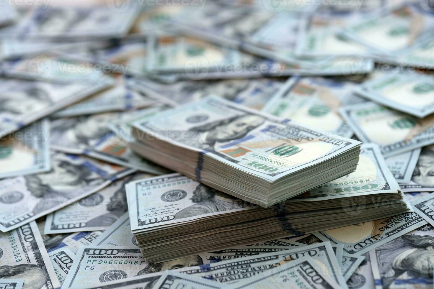 Very big amount of US hundred dollar bills. Huge quantity of united states currency notes on flat table photo