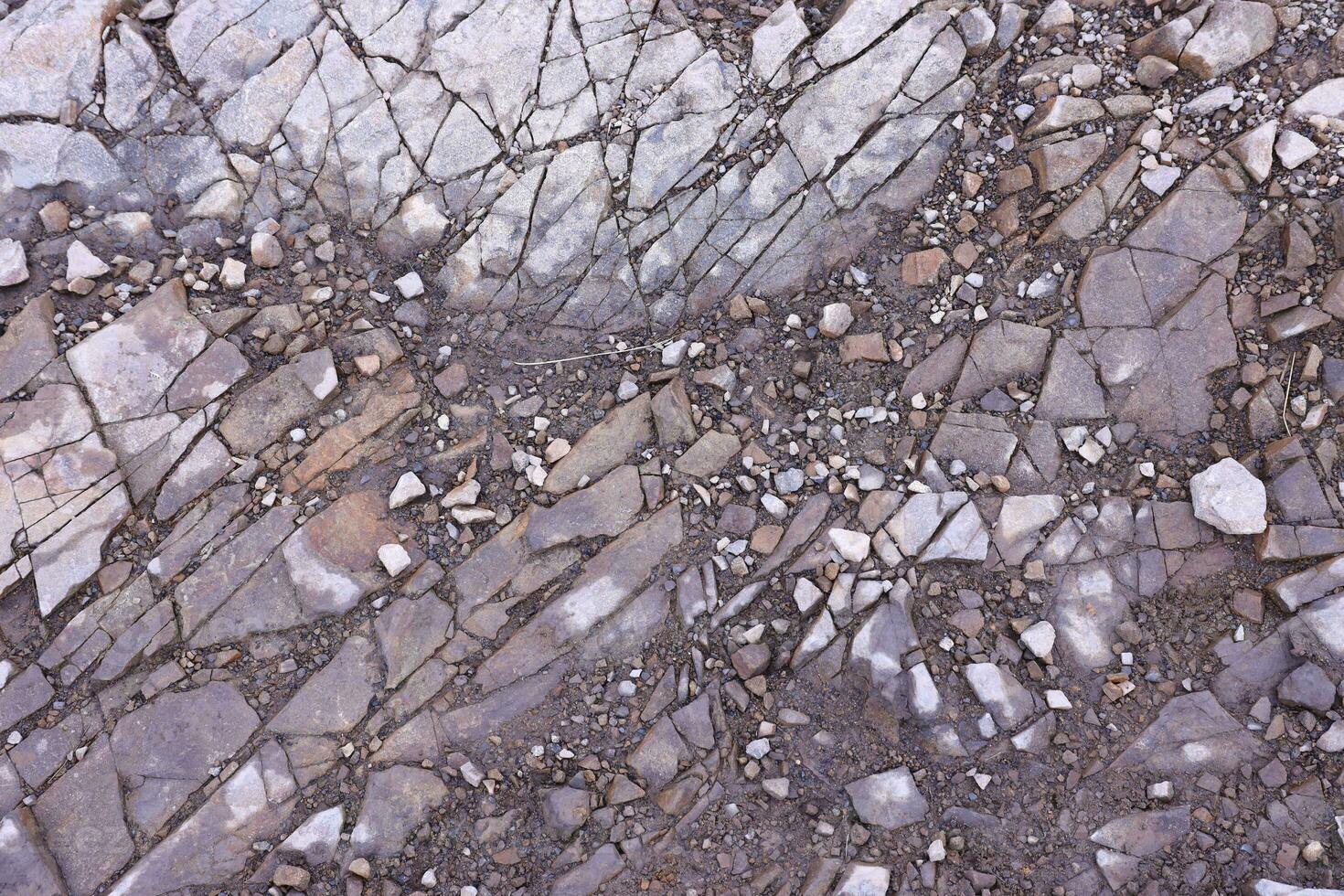 Background of shattered stony stones surface in mountain area. Texture with natural light photo