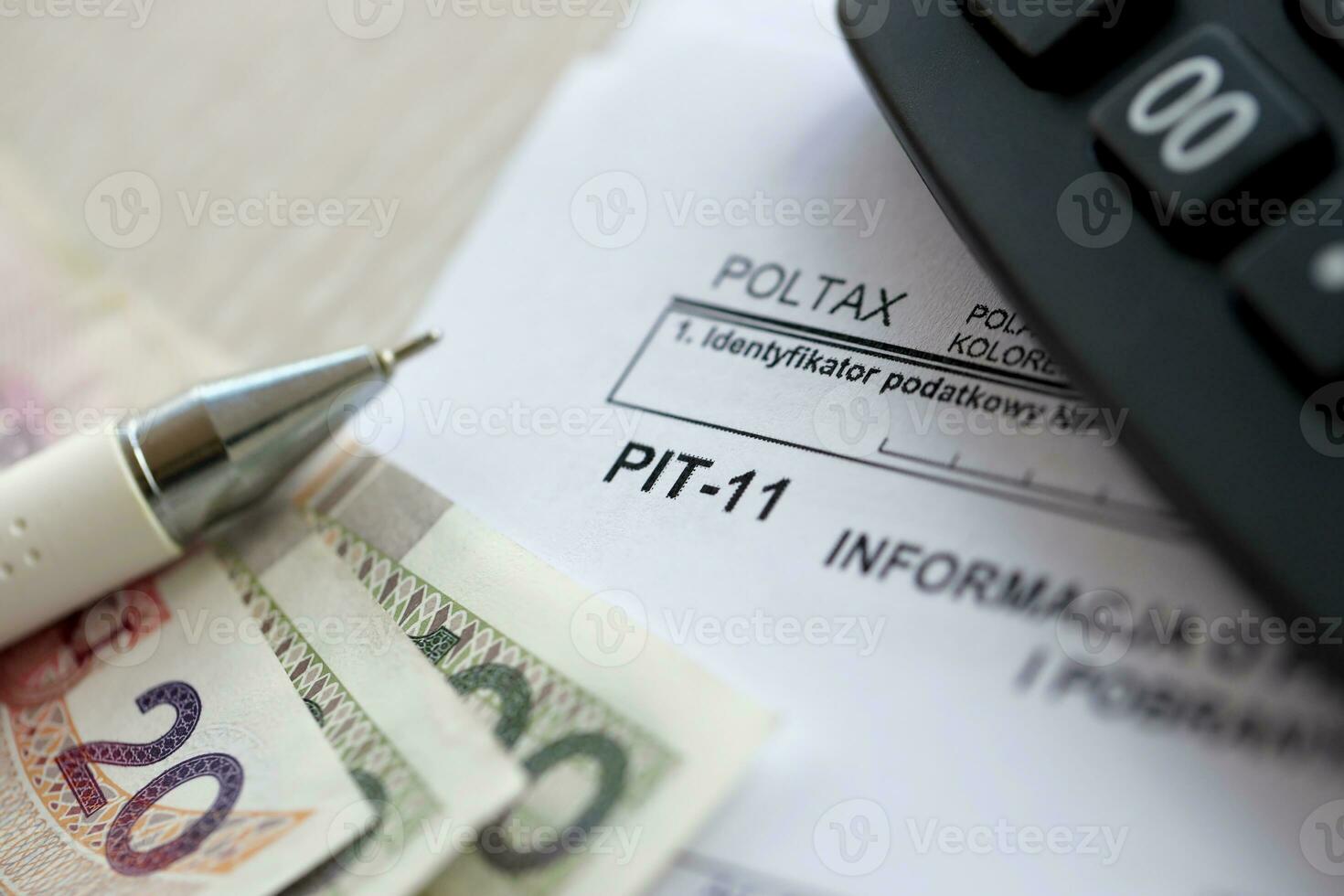Information on revenues from other sources and collected income tax advances, PIT-11 form on accountant table with pen and polish zloty money bills photo