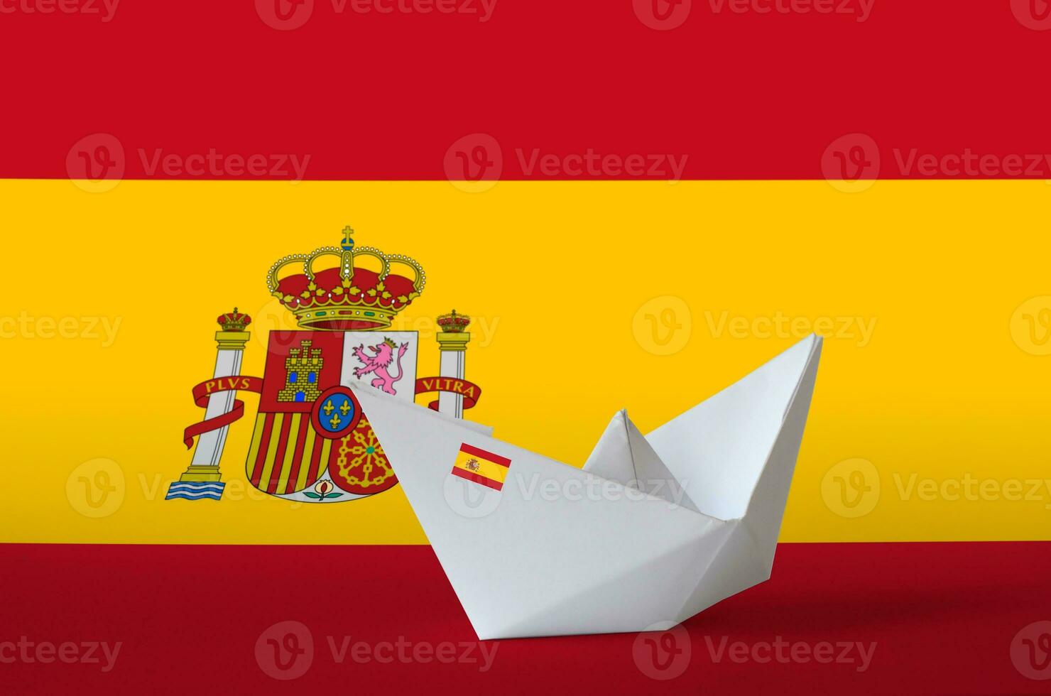 Spain flag depicted on paper origami ship closeup. Handmade arts concept photo