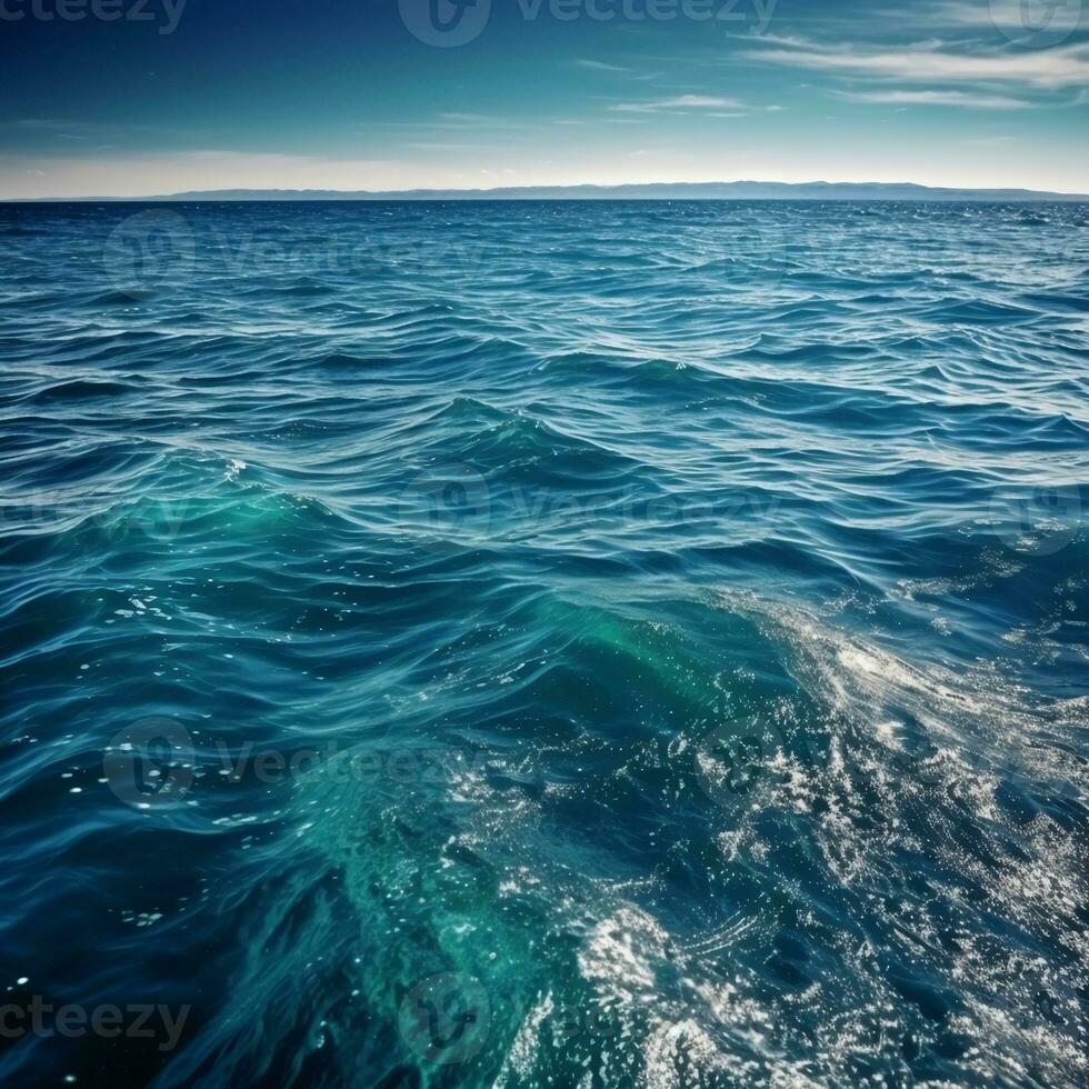 the ocean is calm and blue with waves photo