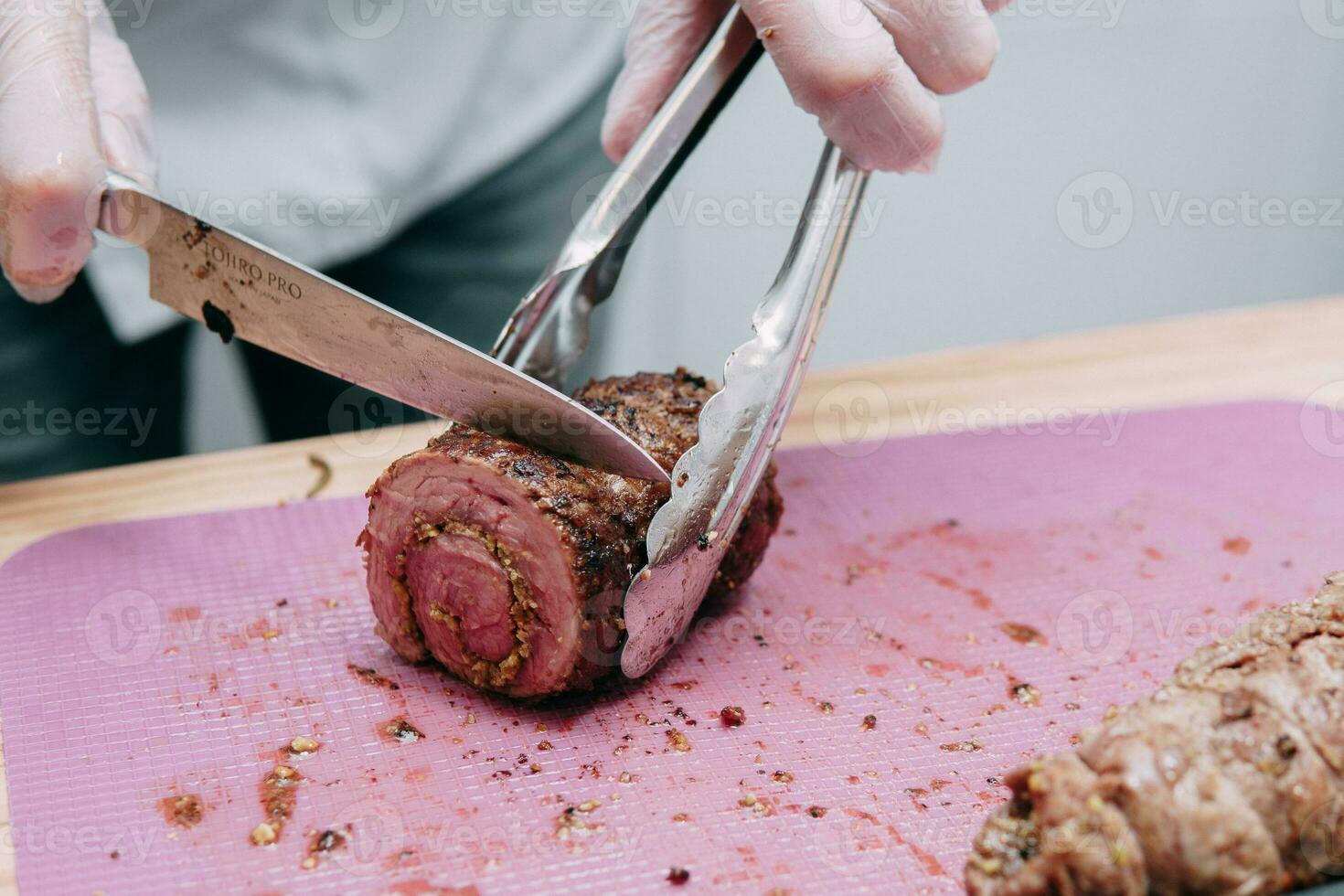 Cooking meat rolls in the cooking class. Beef roll with spices. The process of cutting a roll, close-up. photo