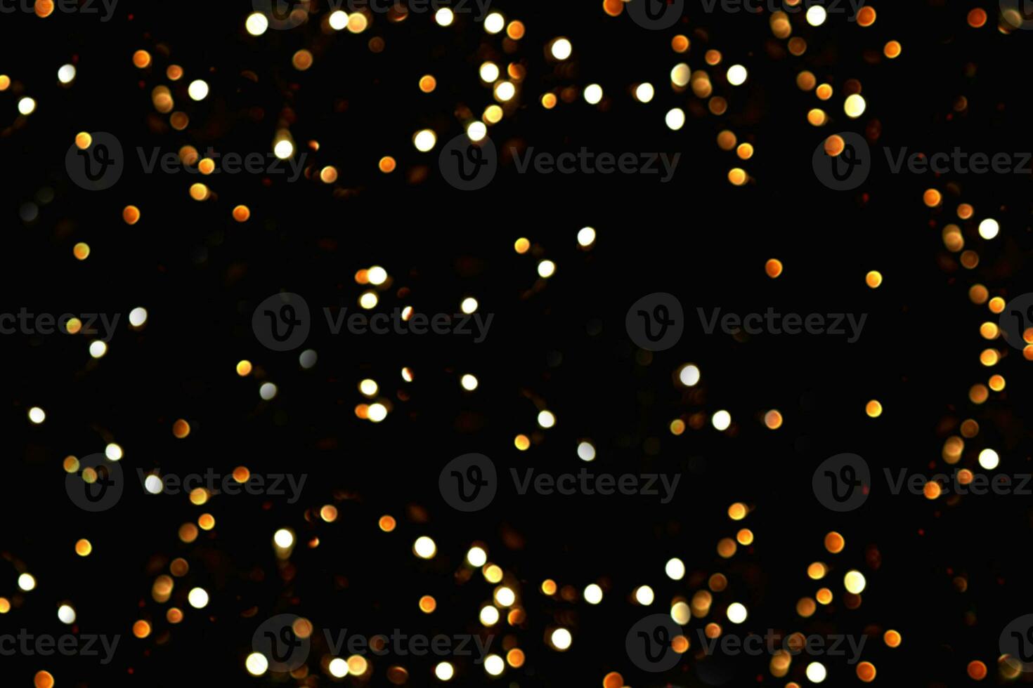 Blurry garland lights on a dark background. Festive Christmas and New Year background. Soft focus photo