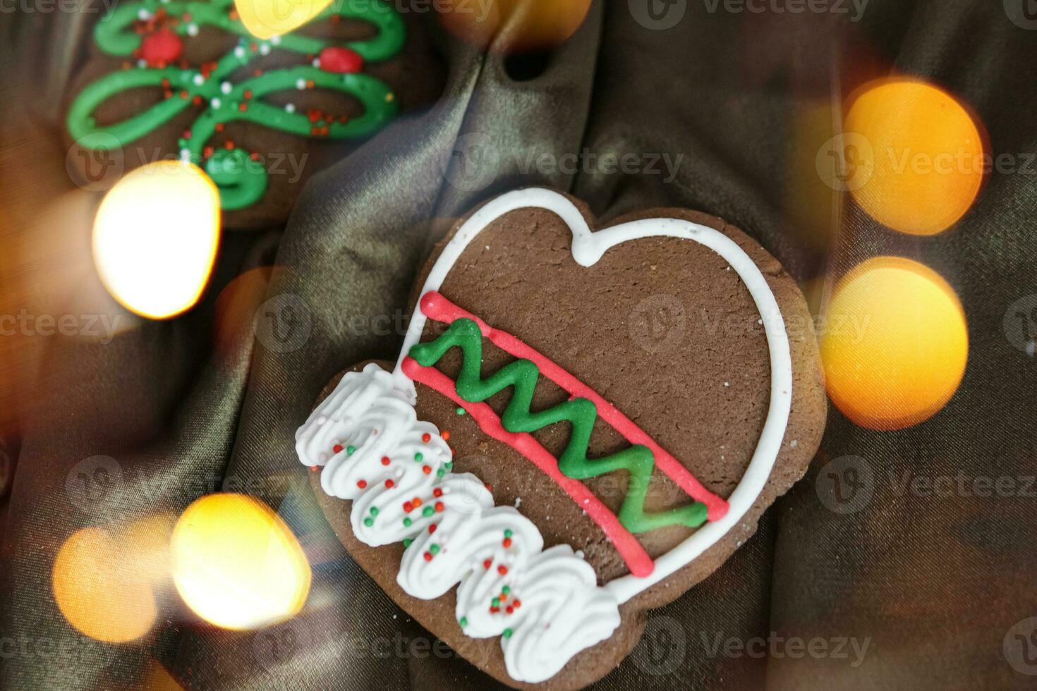 Banner for Christmas and New Year gingerbread. Christmas trees, toys, snowmen, garlands on a background of brown silk fabric. Bright bokeh. photo