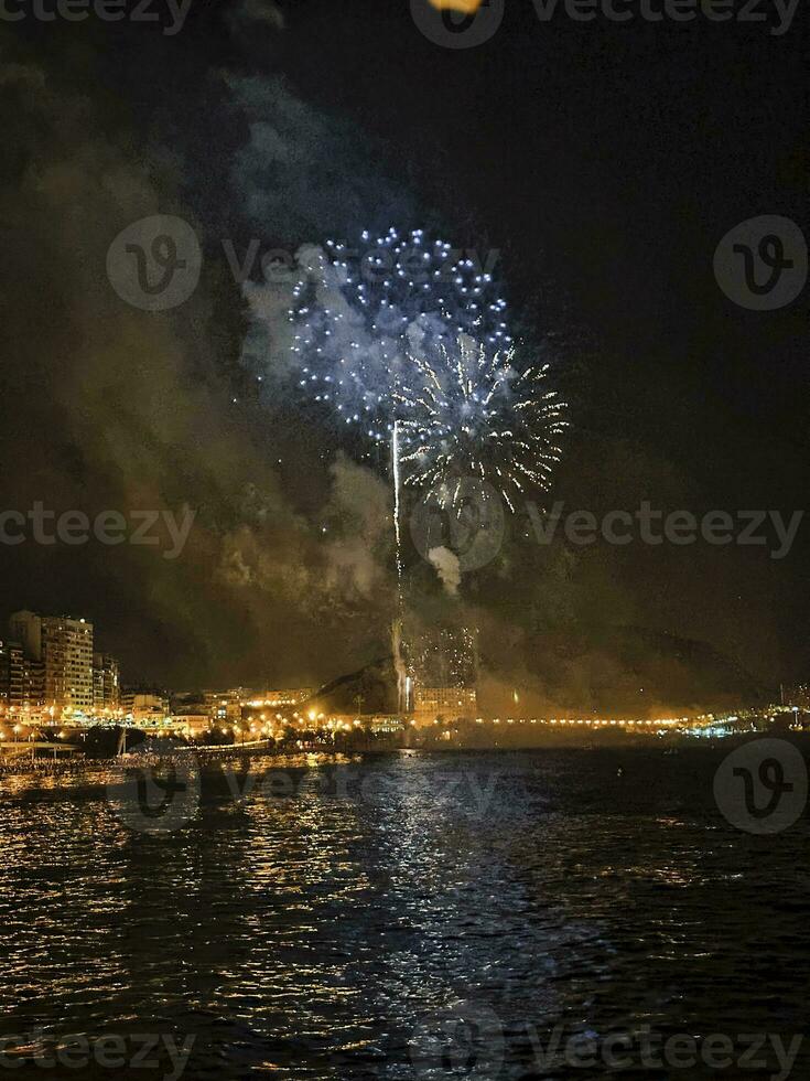 colorful fireworks in the night sky on the seafront of Alicante spain photo