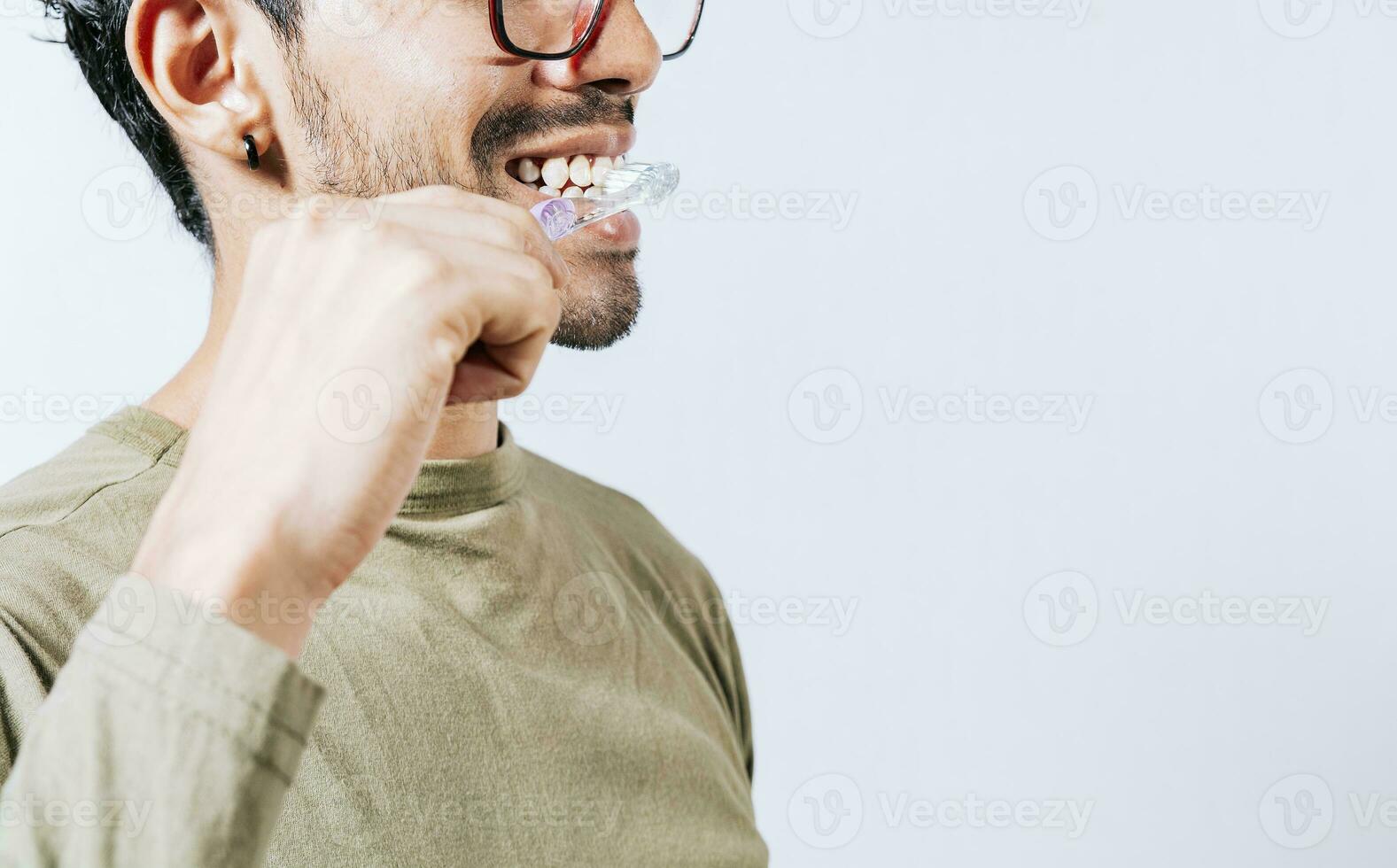 Face of person brushing teeth isolated with copy space. Man brushing his teeth isolated, Face of handsome man brushing his teeth with copy space. Tooth care and brushing concept photo