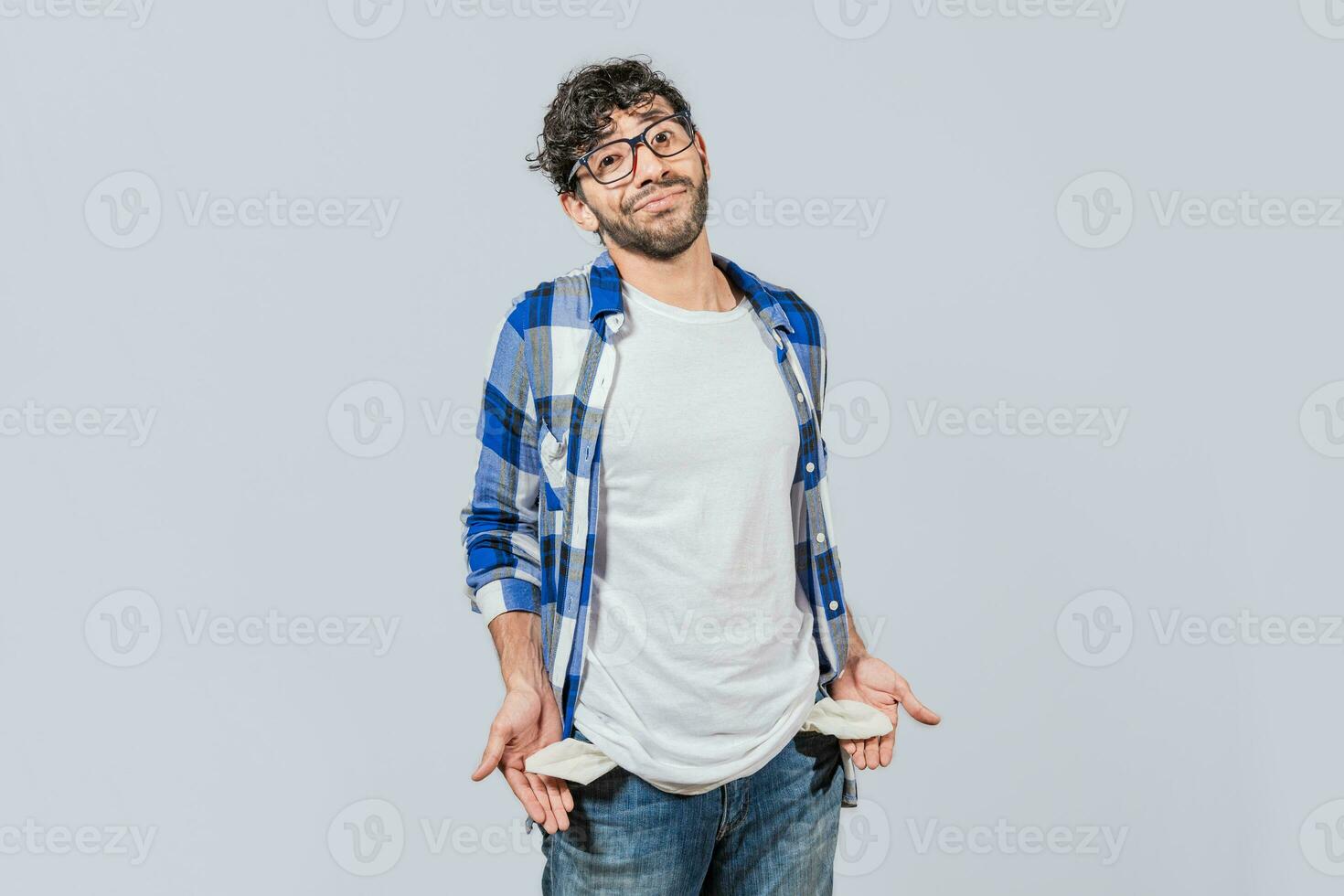 Sad man with no money showing his empty pockets, Unemployed people showing their empty pockets. Frustrated unemployed young man showing his empty pockets. Unemployed people concept photo