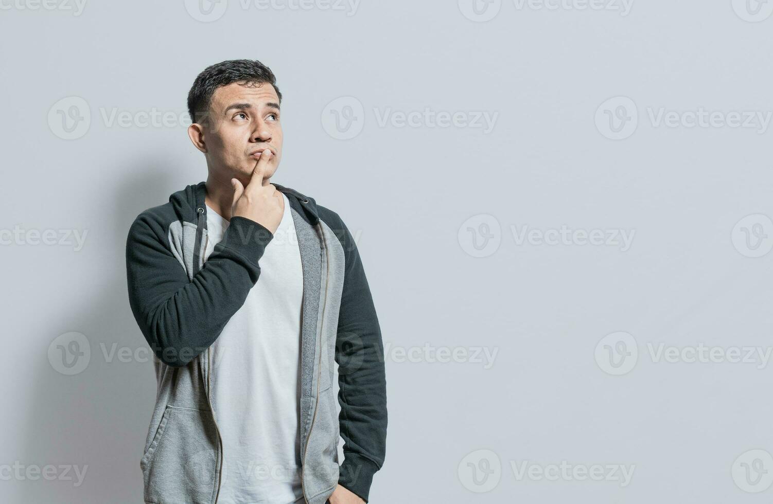 Person wondering with hand on chin isolated, Thoughtful person rubbing his chin, Concept of wondering man with doubt face photo