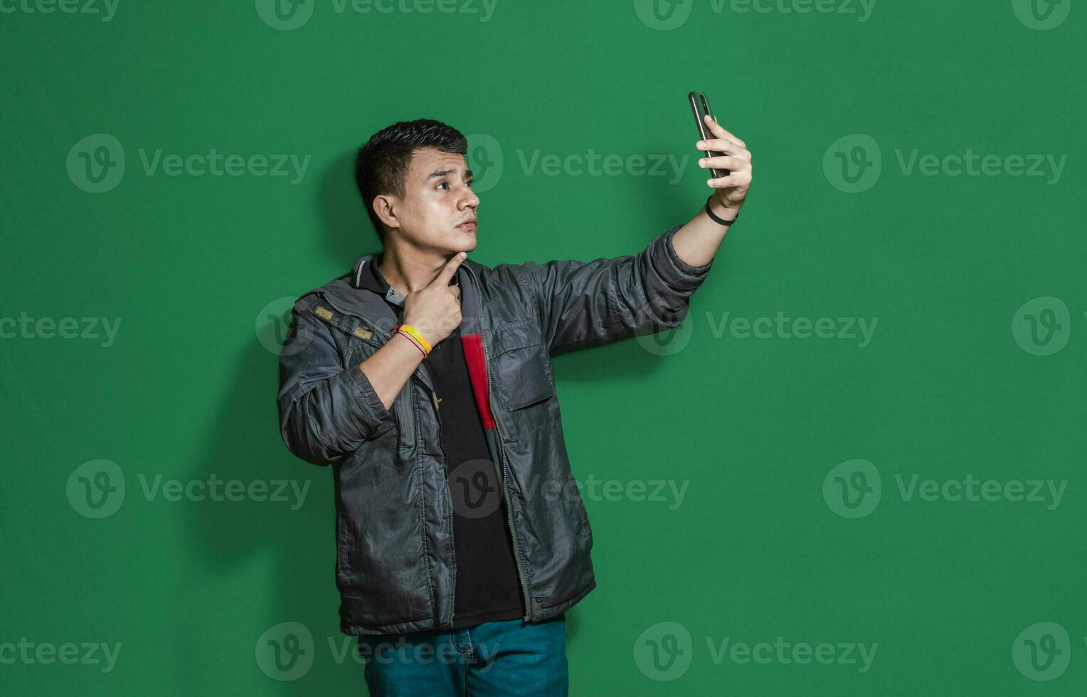 Guy taking photo isolated, man taking some selfie with isolated background