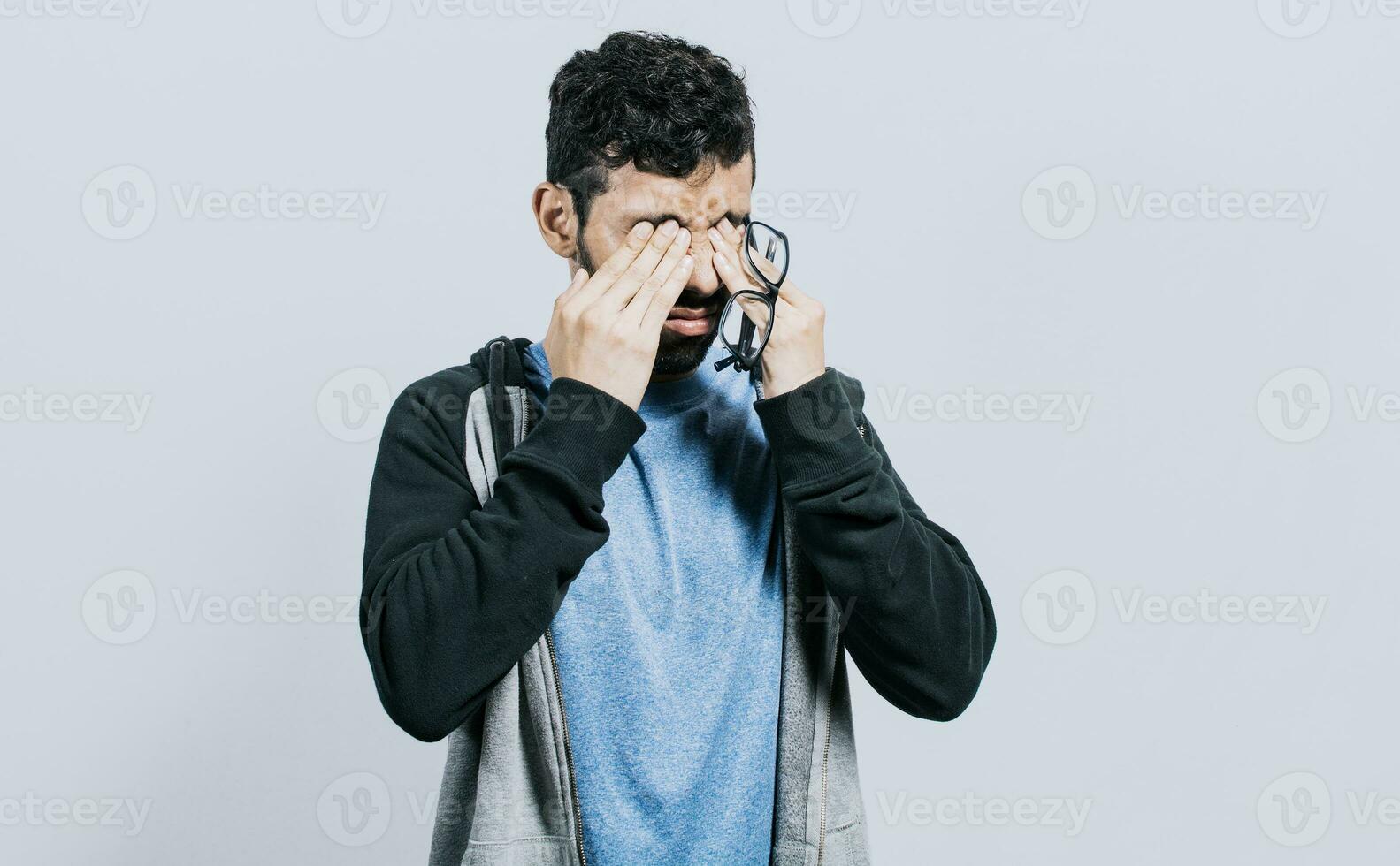 Person with visual fatigue isolated, Man with glasses with visual fatigue, concept of person with asthenopia, Person with glasses with visual pain photo