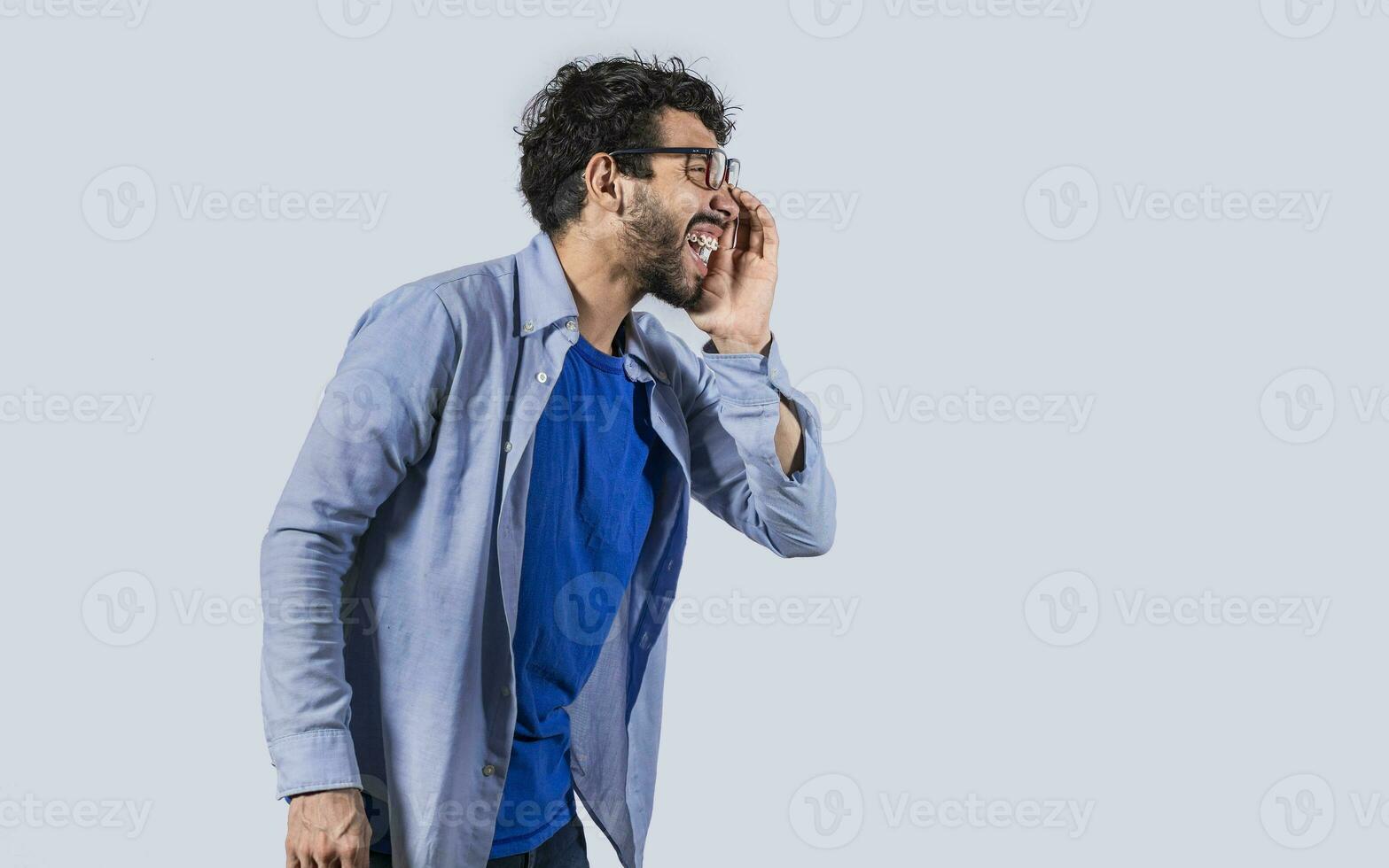 Side view of a man shouting out loud, A person announcing and yelling, side view of a man holding hand near mouth announcing news photo