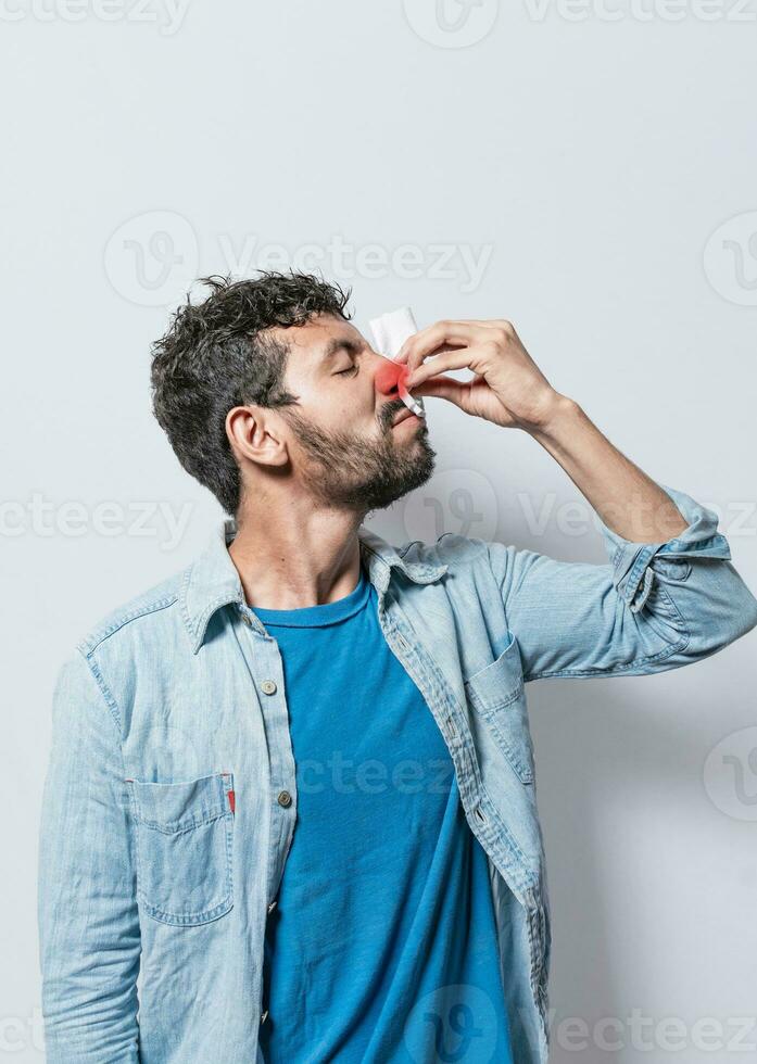 Person with nasal congestion, Person with irritated nose on isolated background, man with red nose cold, concept of person with sinusitis photo