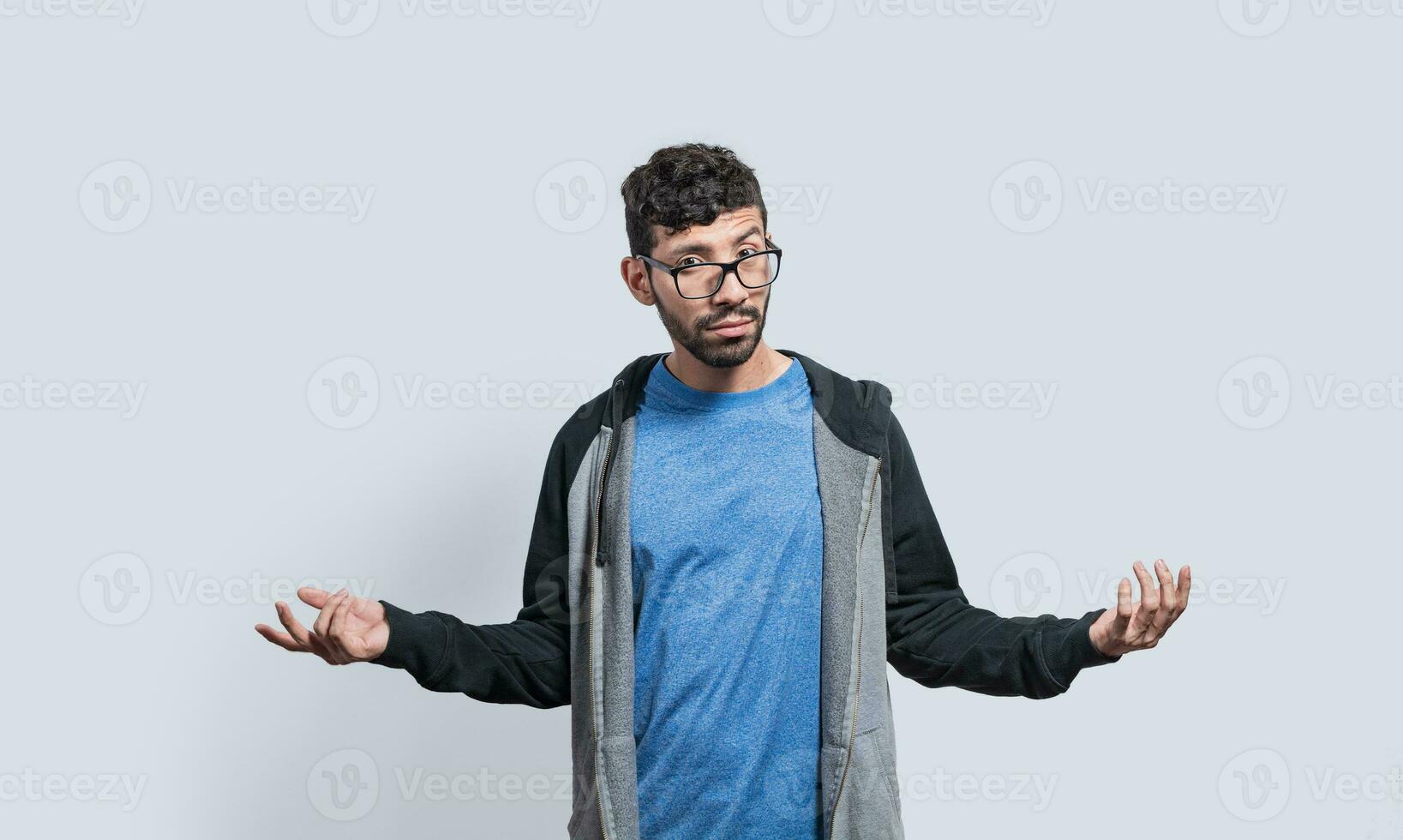Puzzled person spreading hands, Clueless person with open arms, Man with a face of not having an answer photo