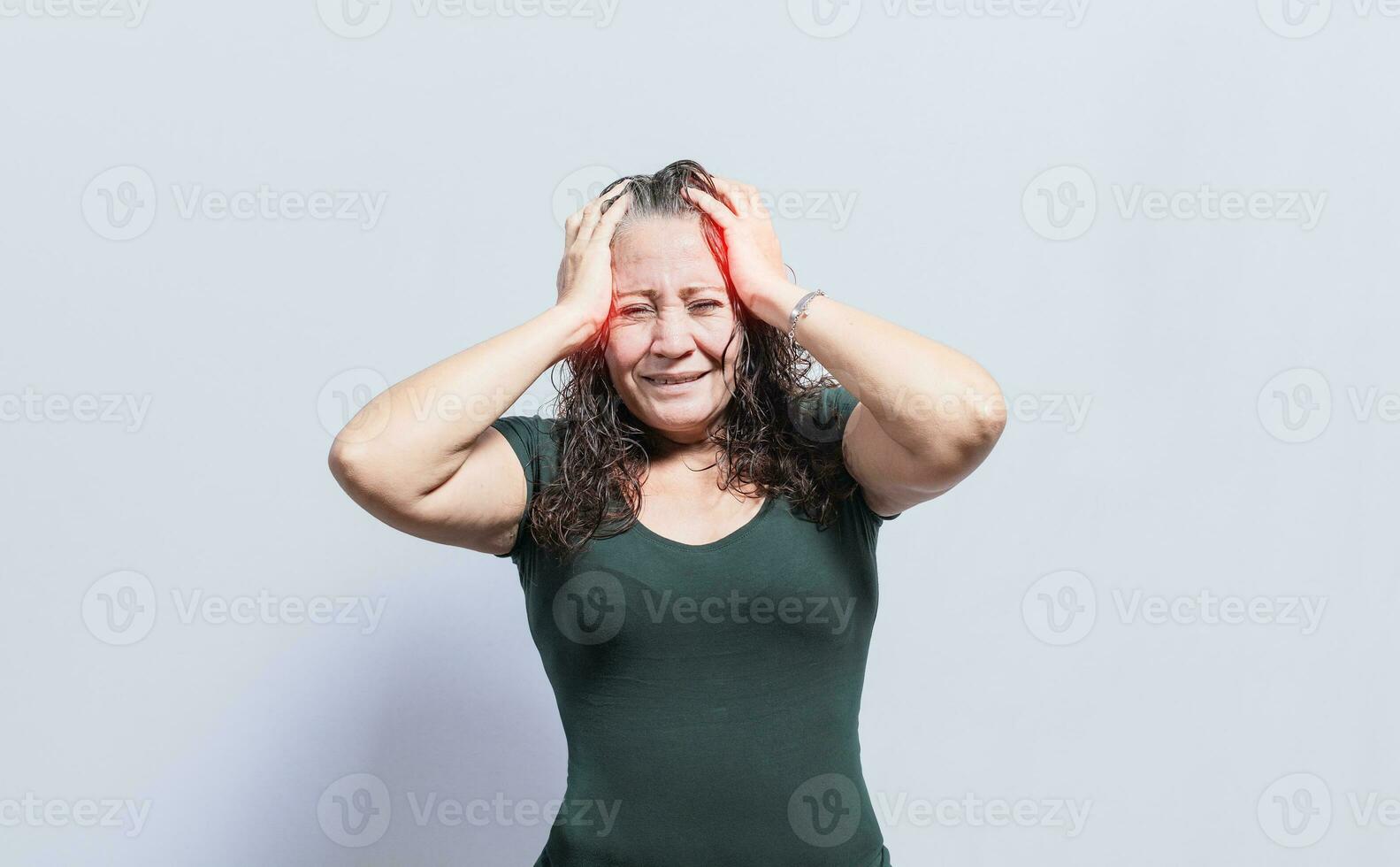 Woman with headache on isolated background, Concept of a person with a headache, Woman giving herself a head massage, Concept of a man with a migraine photo