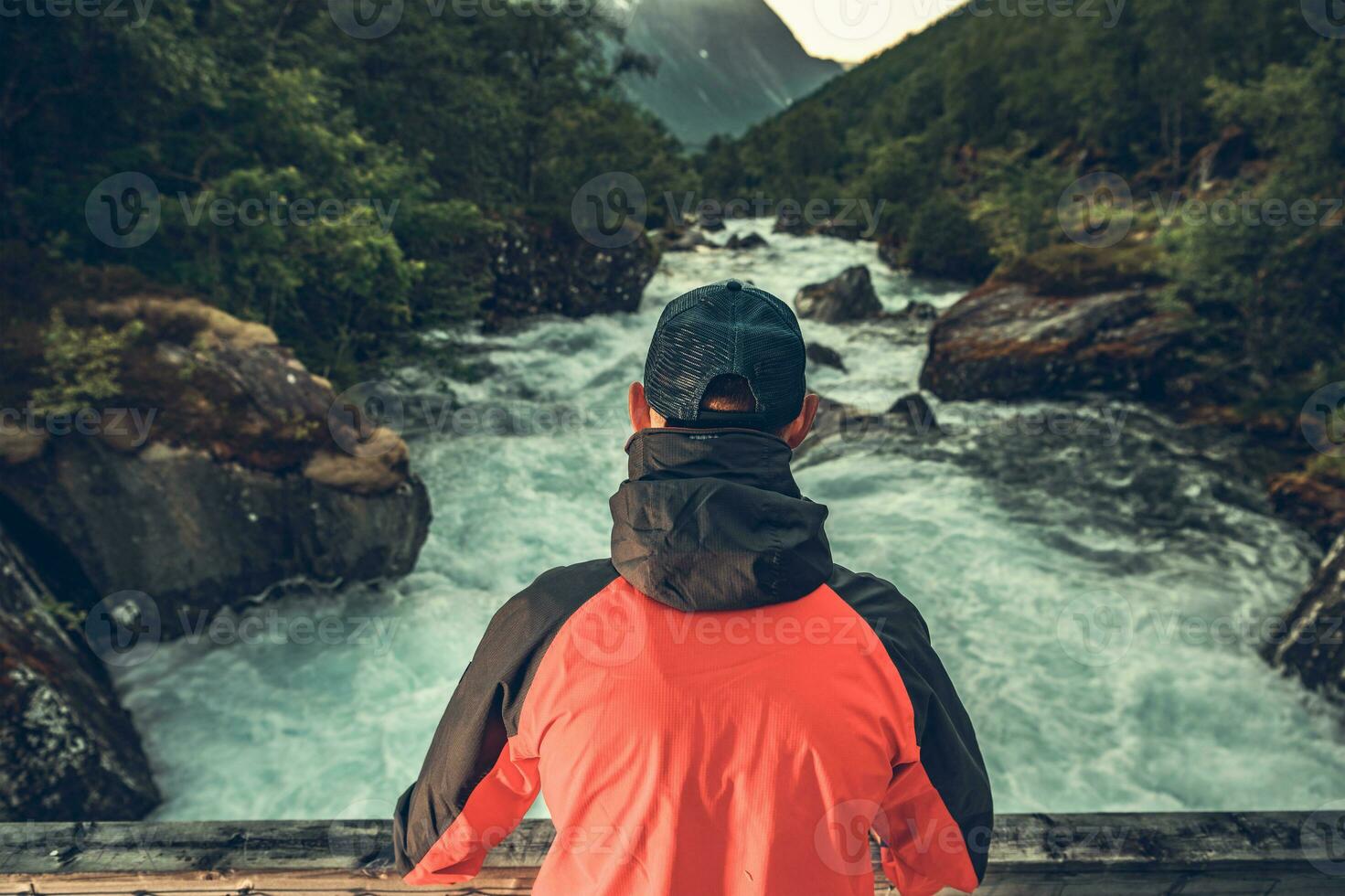Hiker Staying in Front of Scenic Norwegian River photo