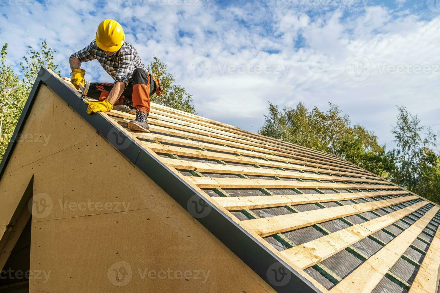 Professional Construction Worker Assembling Roof Wooden Elements photo