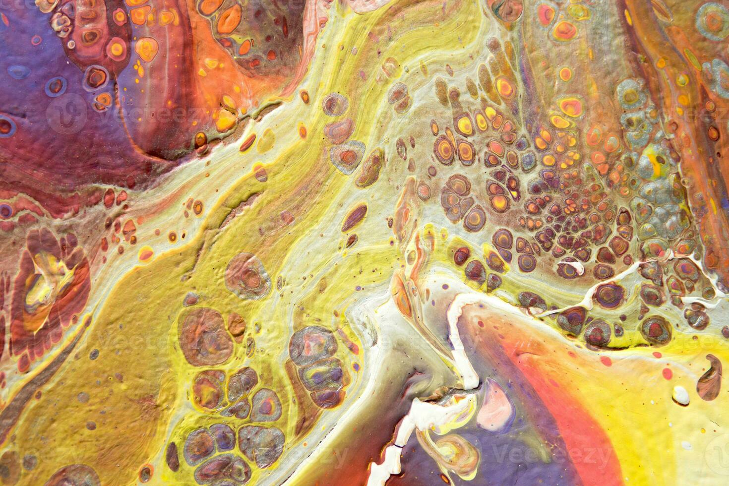 Spread-out acrylic paint. Abstract background, made in the technique of fluid art. Fashionable colorful background in warm colors photo