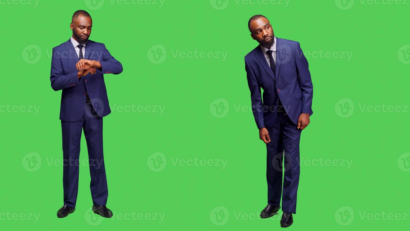 Young adult checking hour on wristwatch and waiting in studio, looking at clock before working on business company. Startup entrepreneur in suit posing with confidence in studio. photo