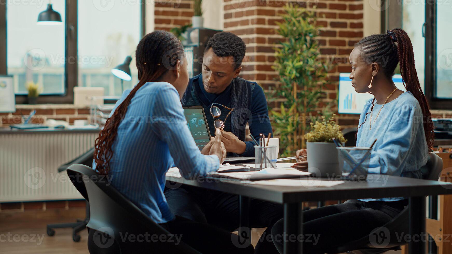 Business partners creating presentation in boardroom, looking at annual report plans on documents. Corporate workers doing teamwork meeting in offce, examining analytics results. photo