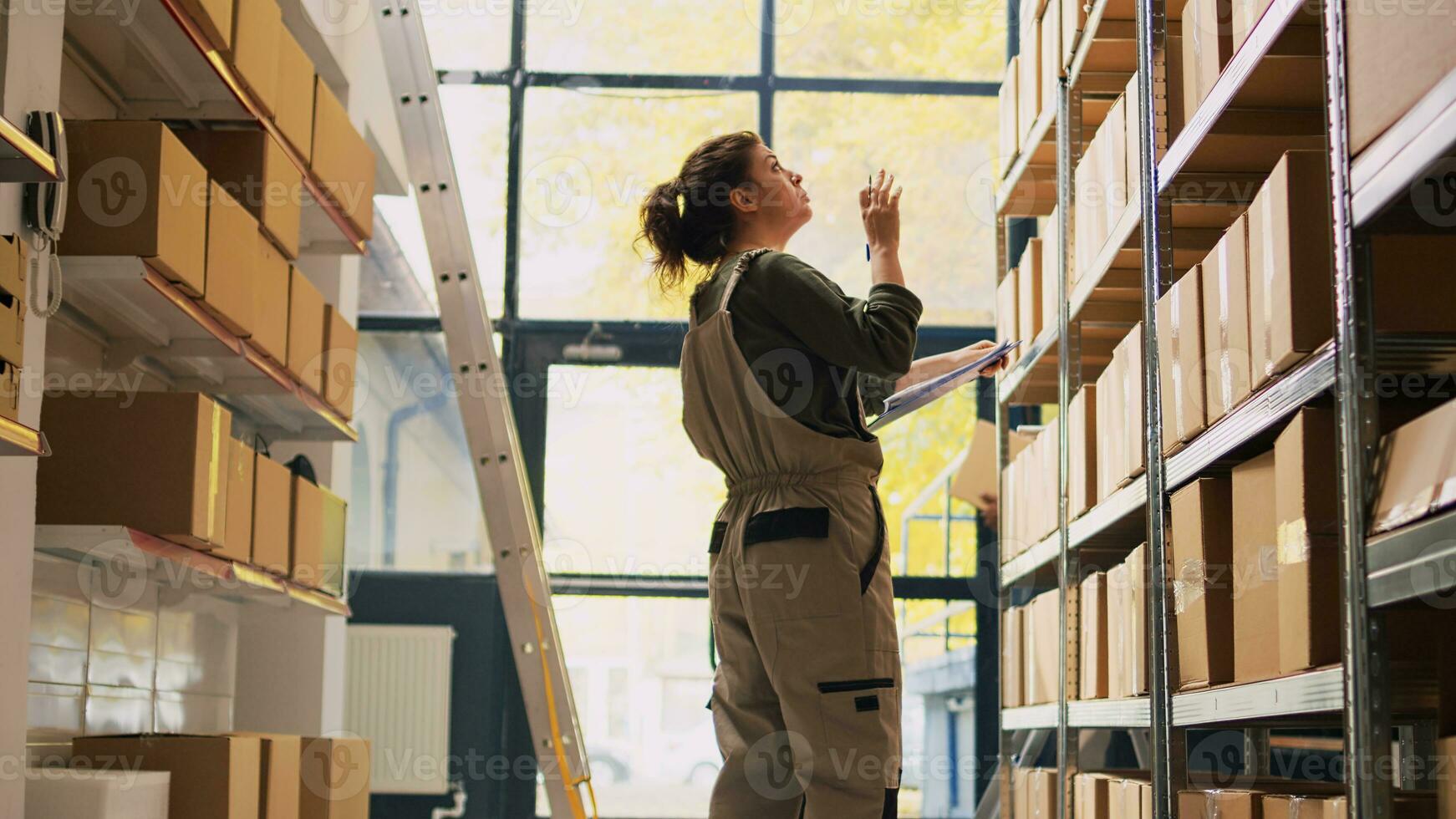 Young Logistic Manager Organizing Boxes In Storage by Stocksy