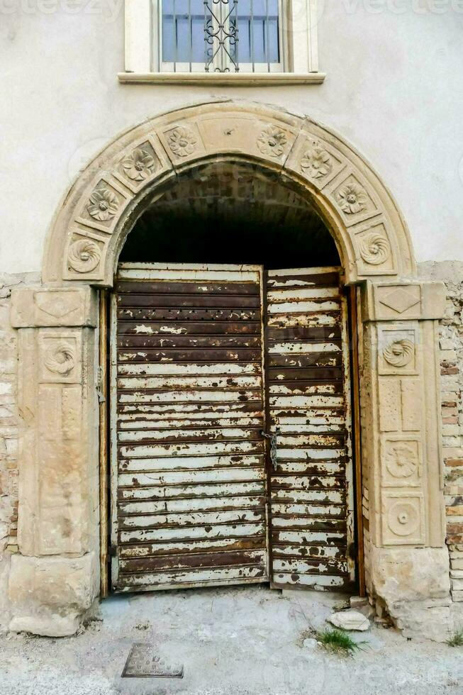 an old wooden door with a window above it photo