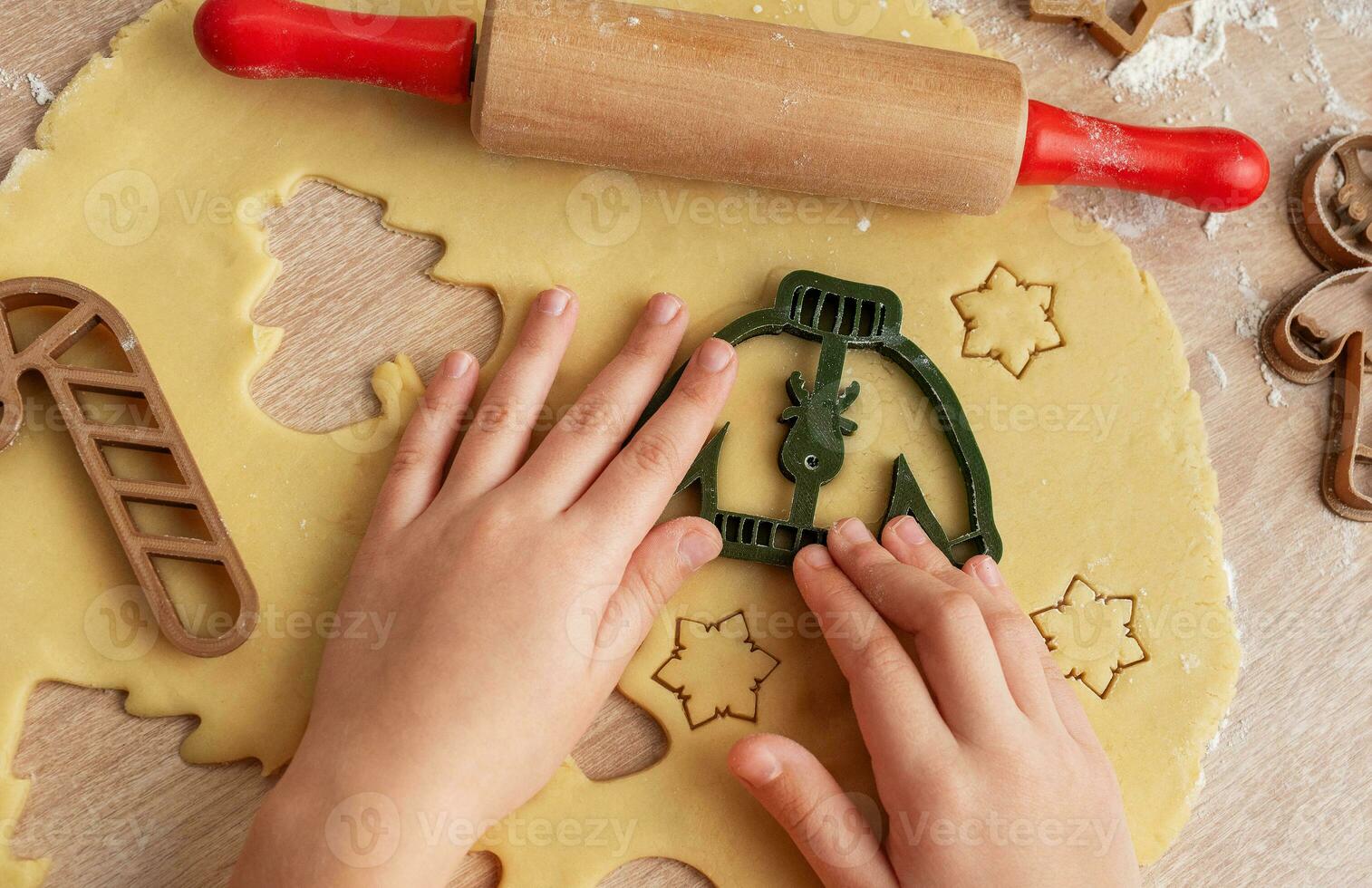 Children's hands with gingerbread cookies on wooden background photo