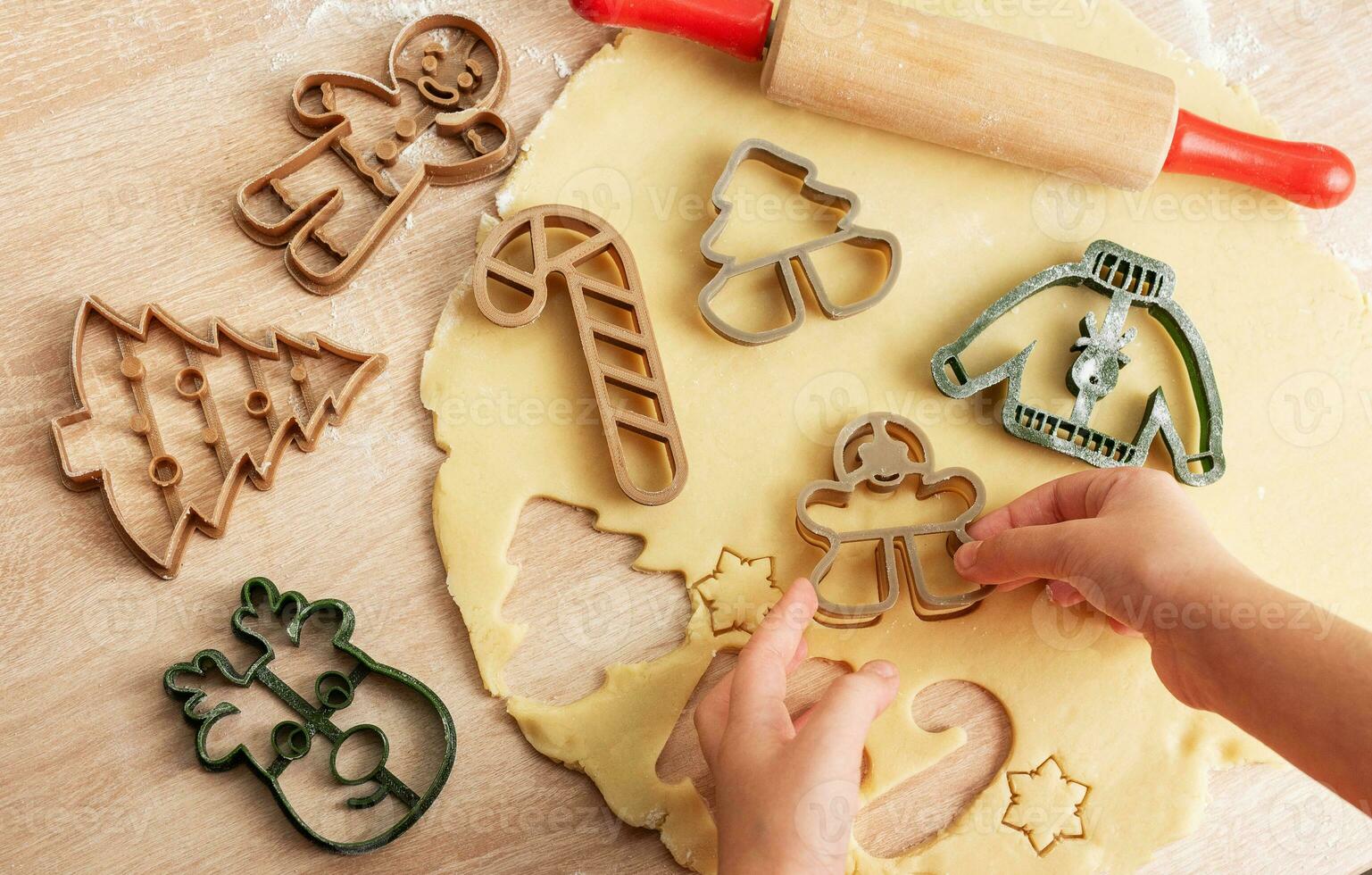 Children's hands with gingerbread cookies on wooden background photo