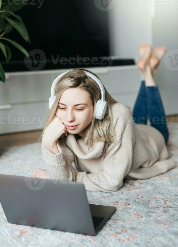 Young caucasian woman relaxes at home with music photo