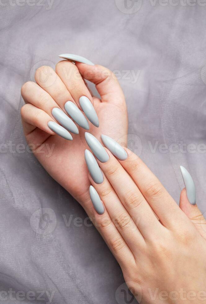 Grey nails on grey lace background. photo