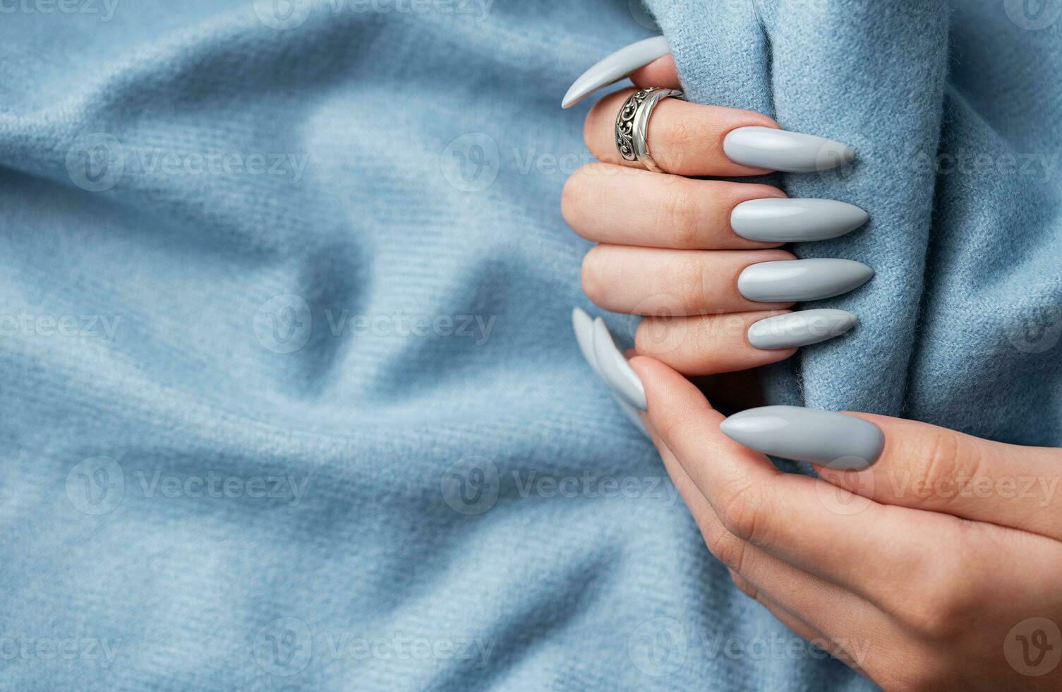 Blue manicure nails with a blue scarf photo