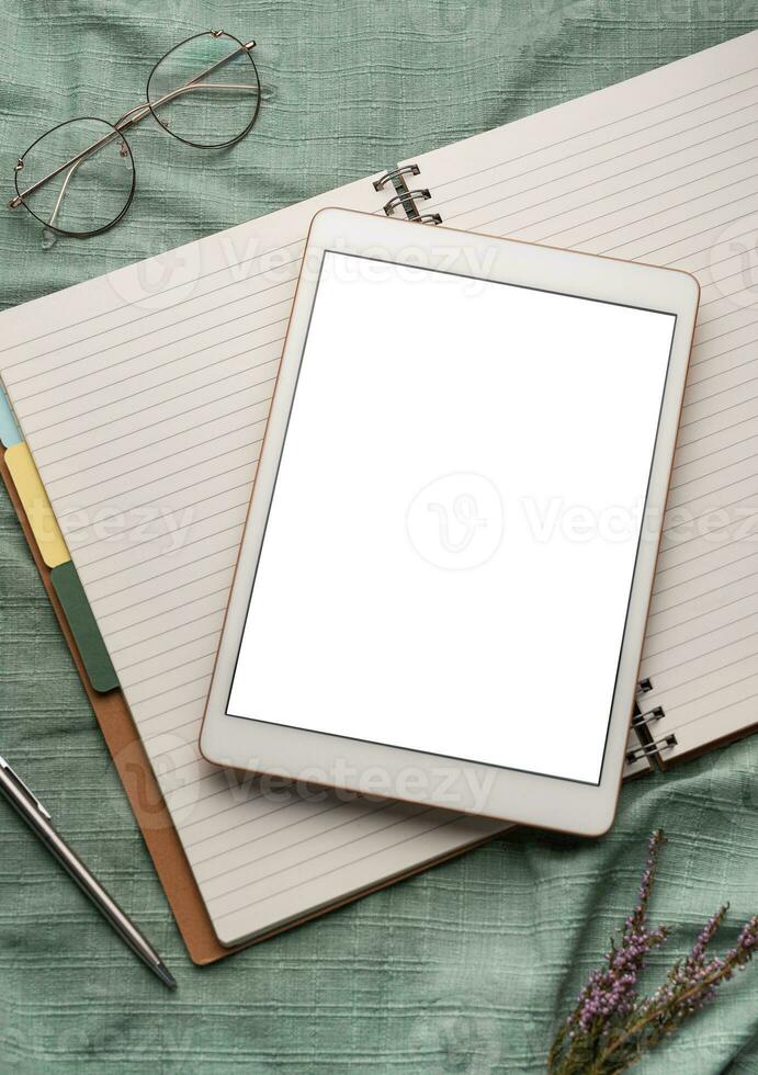 Tablet pc  and notebooks  on the office desk photo