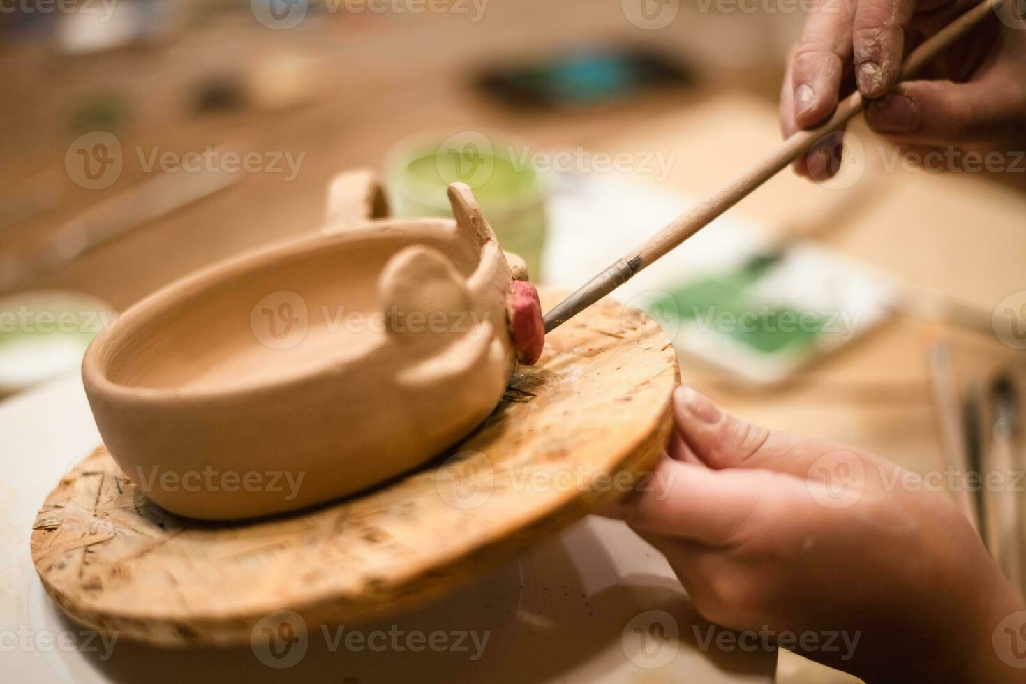 girl hands, pottery studio and painting cup in workshop for sculpture photo