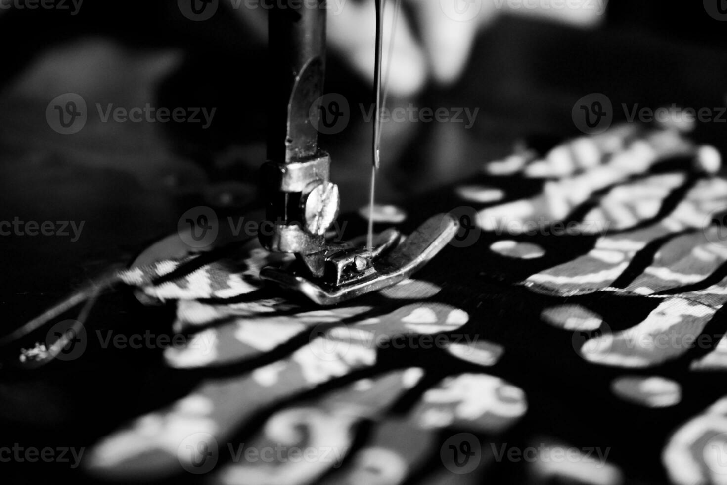 Vintage Black and White Close up Senior Female Tailor Sewing batik indonesian fabric into cloth, elder senior and vintage black and white concept photo