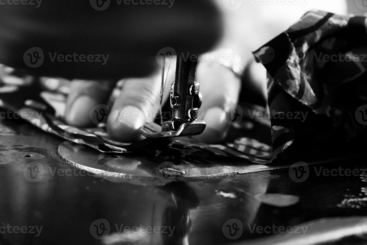 Vintage Black and White Close up Senior Female Tailor Sewing batik indonesian fabric into cloth, elder senior and vintage black and white concept photo