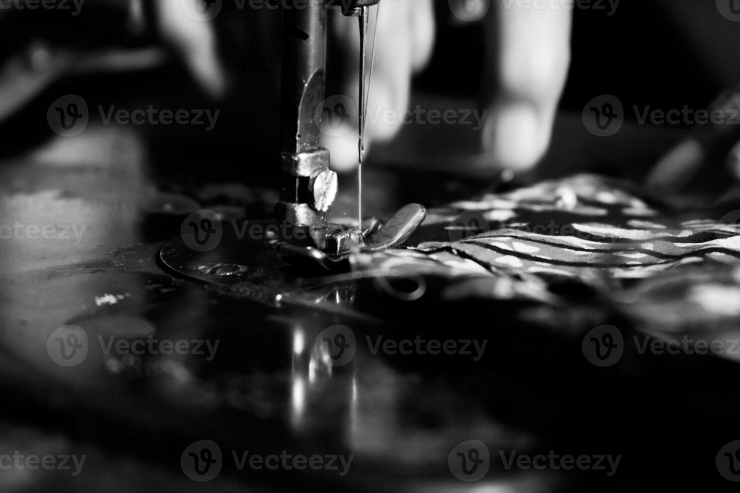 Vintage Black and White Close up Senior Female Tailor Sewing batik indonesian fabric into cloth, elder senior and vintage black and white concept photo