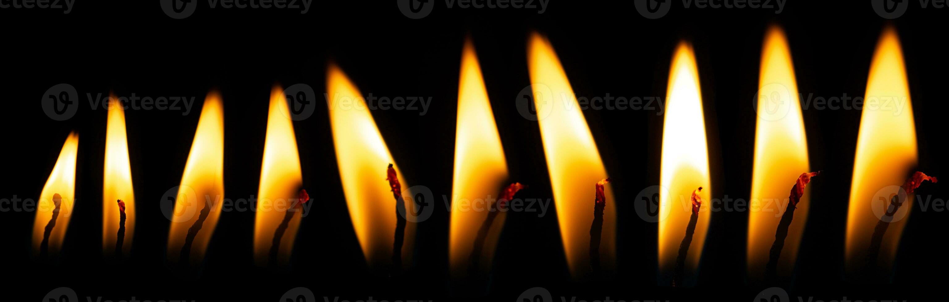Candle flame on black isolated background. Light burning yellow-orange fire. Set collection photo