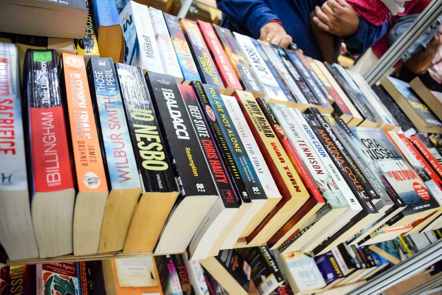 New Delhi, India, September 09 2023 - Variety of Books on shelf inside a book-stall at Delhi International Book Fair, Selection of books on display in Annual Book Fair. photo