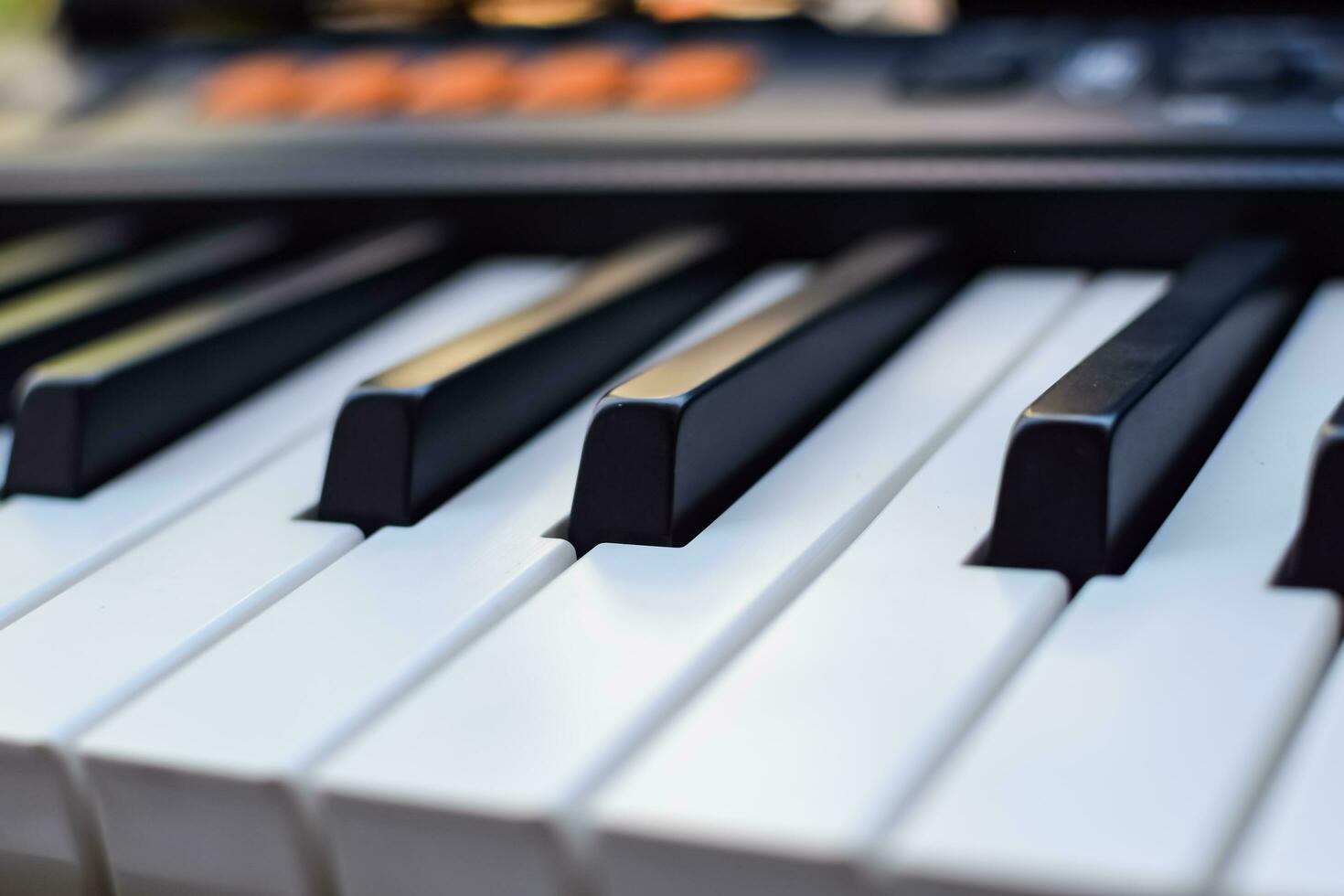 Close-up of piano keys. Piano black and white keys and Piano keyboard musical instrument placed at the home balcony during sunny day. photo