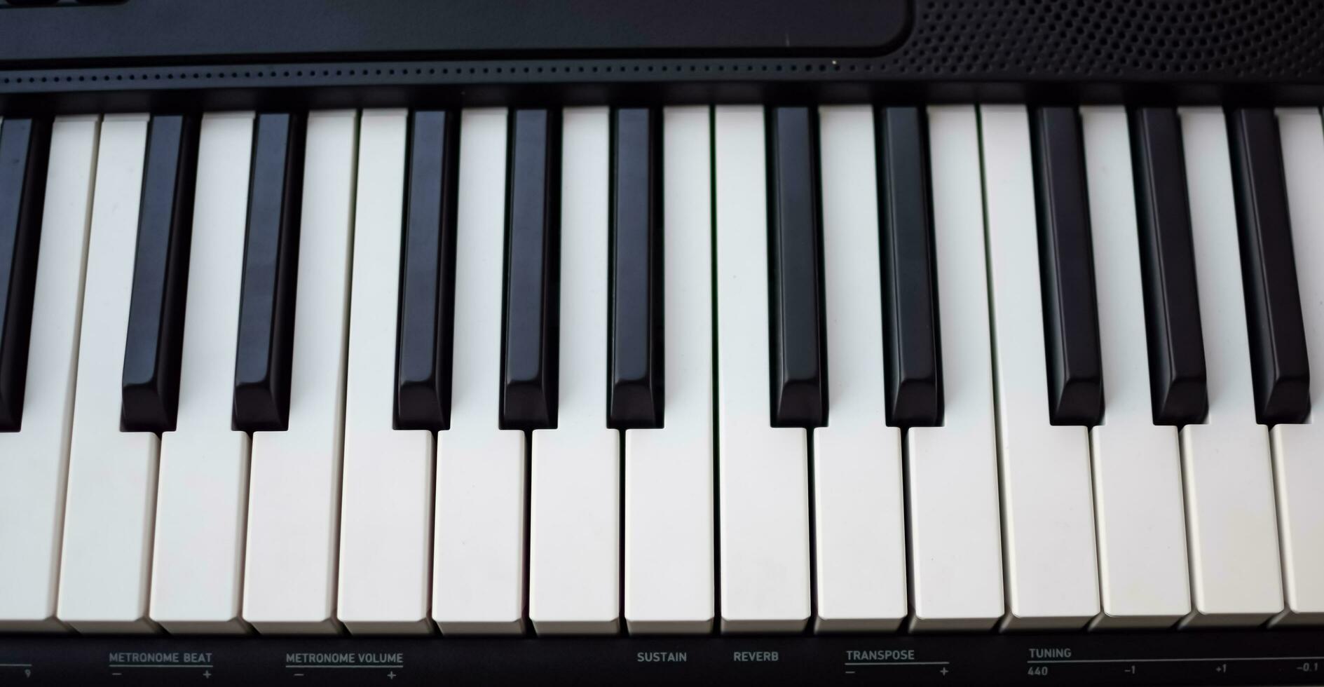 Close-up of piano keys. Piano black and white keys and Piano keyboard musical instrument placed at the home balcony during sunny day. photo