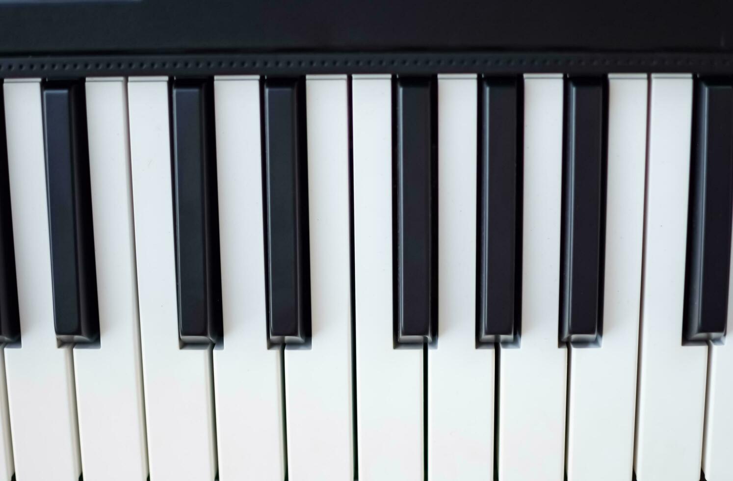 Close-up of piano keys. Piano black and white keys and Piano keyboard musical instrument placed at the home balcony during sunny day. photo