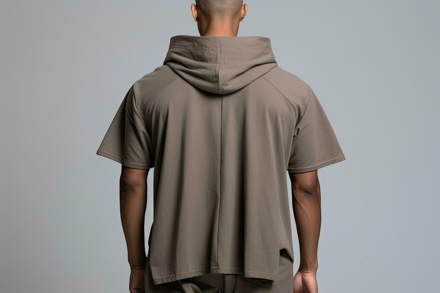 back view of man in blank grey t-shirt on grey background, Male model wearing a deep ash color Hooded tshirt on a White background, front view and back view, top section cropped, AI Generated photo